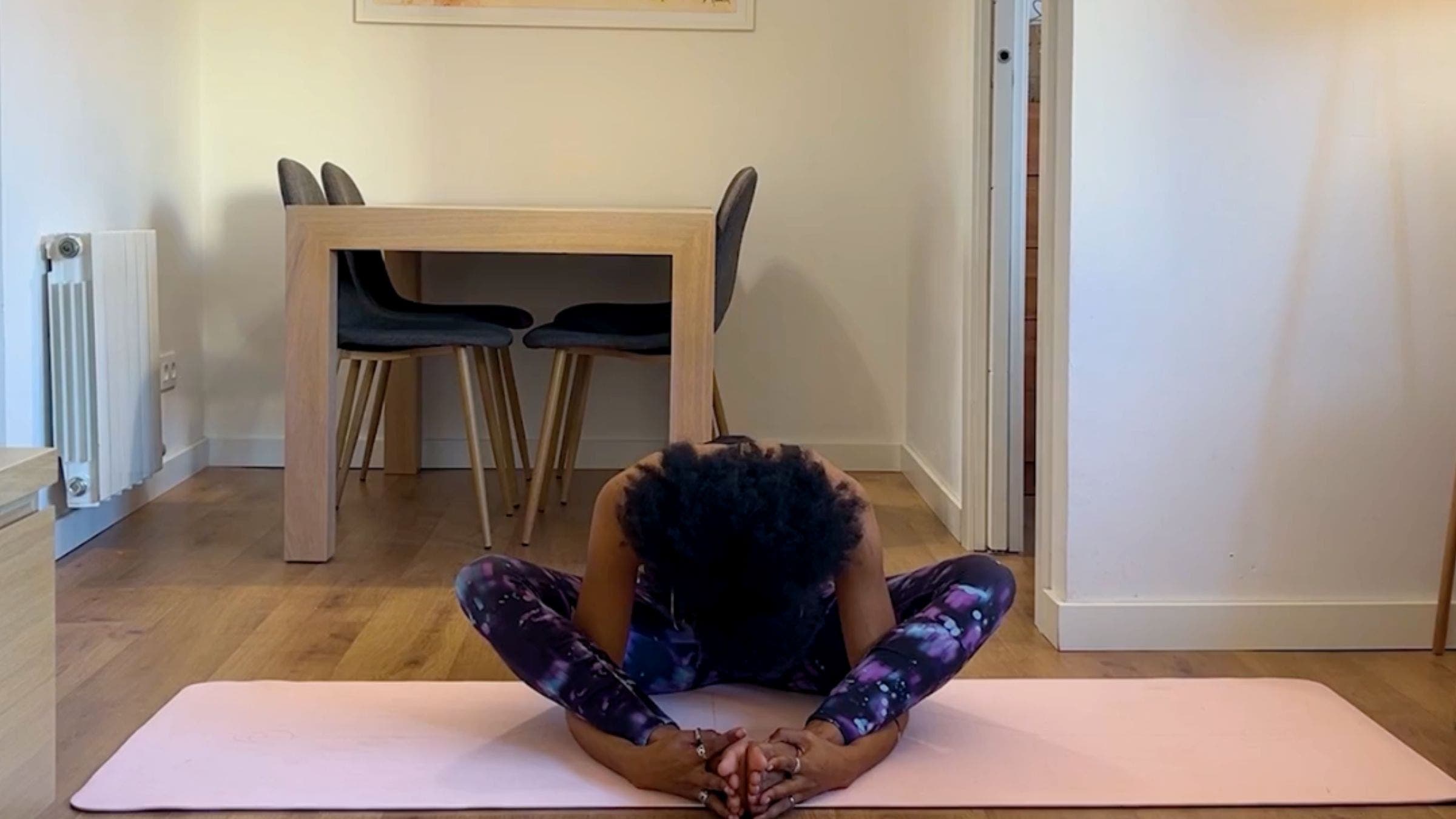 Yoga teacher practicing bound angle pose.