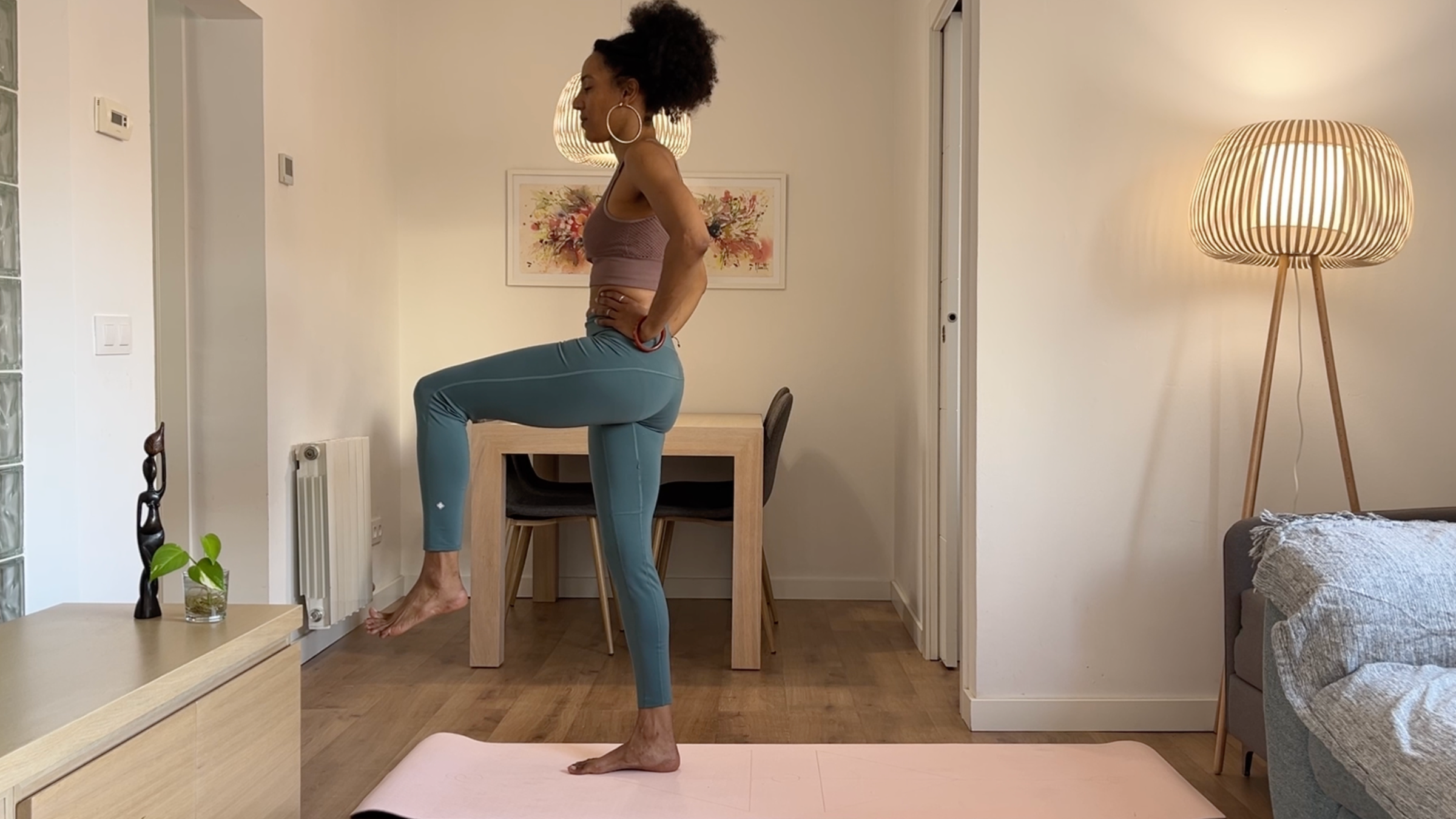 Yoga teacher practicing standing balancing pose.