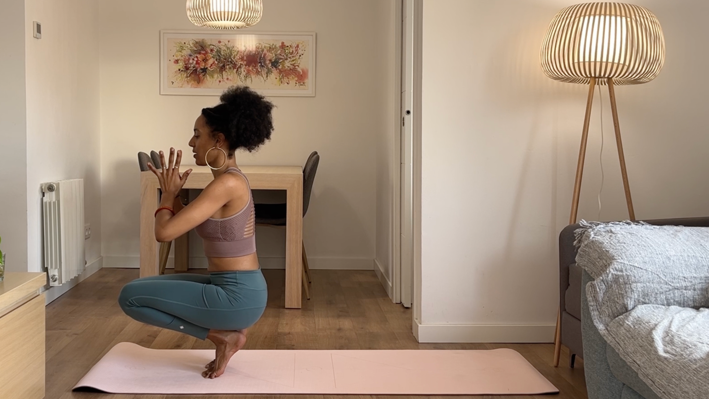 Yoga teacher practicing Squat variation.