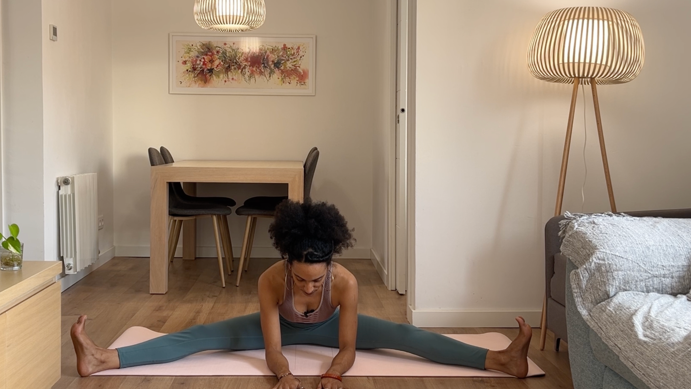 Yoga teacher practicing Wide-Legged Forward Bend.