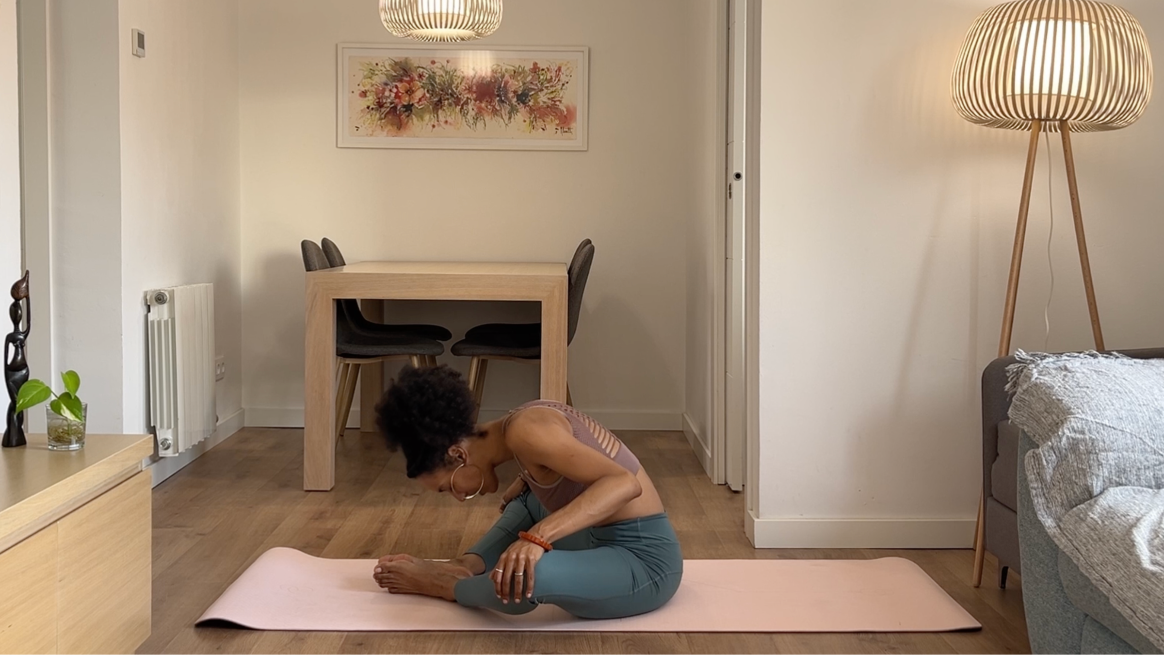 Yoga teacher practicing Bound Angle Pose.