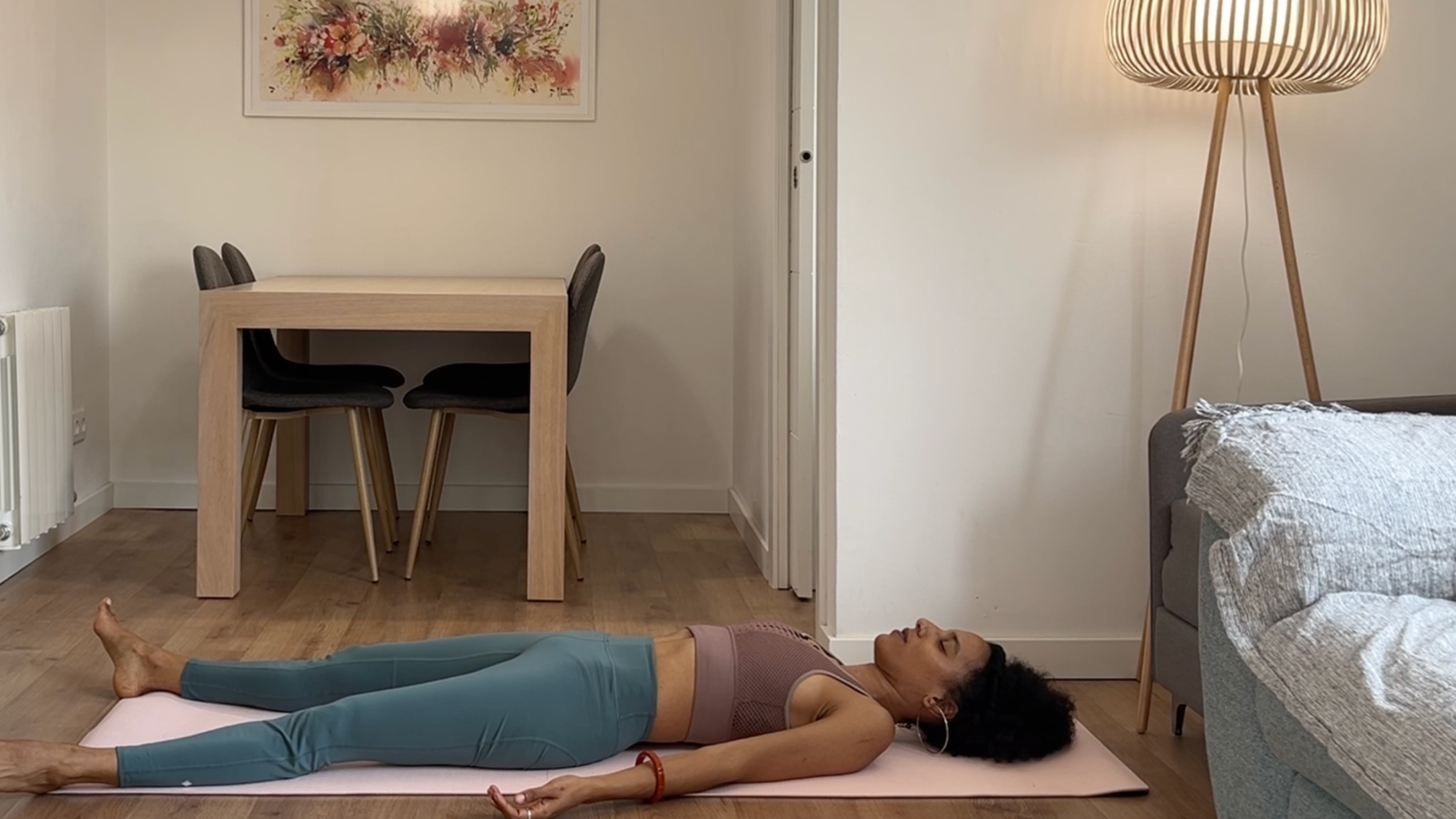 Yoga teacher practicing Savasana.