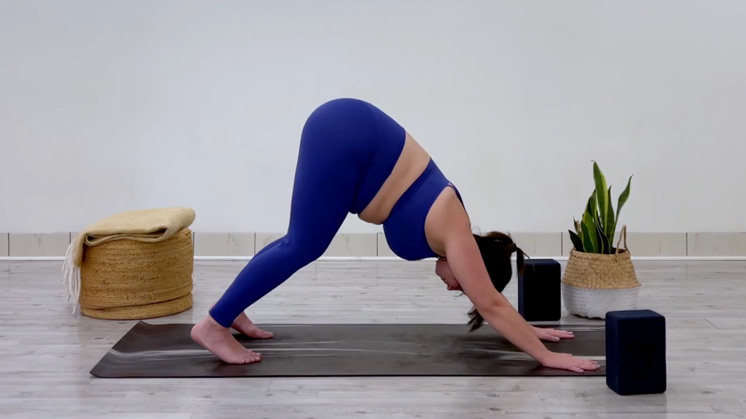 Teacher Taylor Lorenz in Downward-Facing Dog, part of her good mood yoga practice