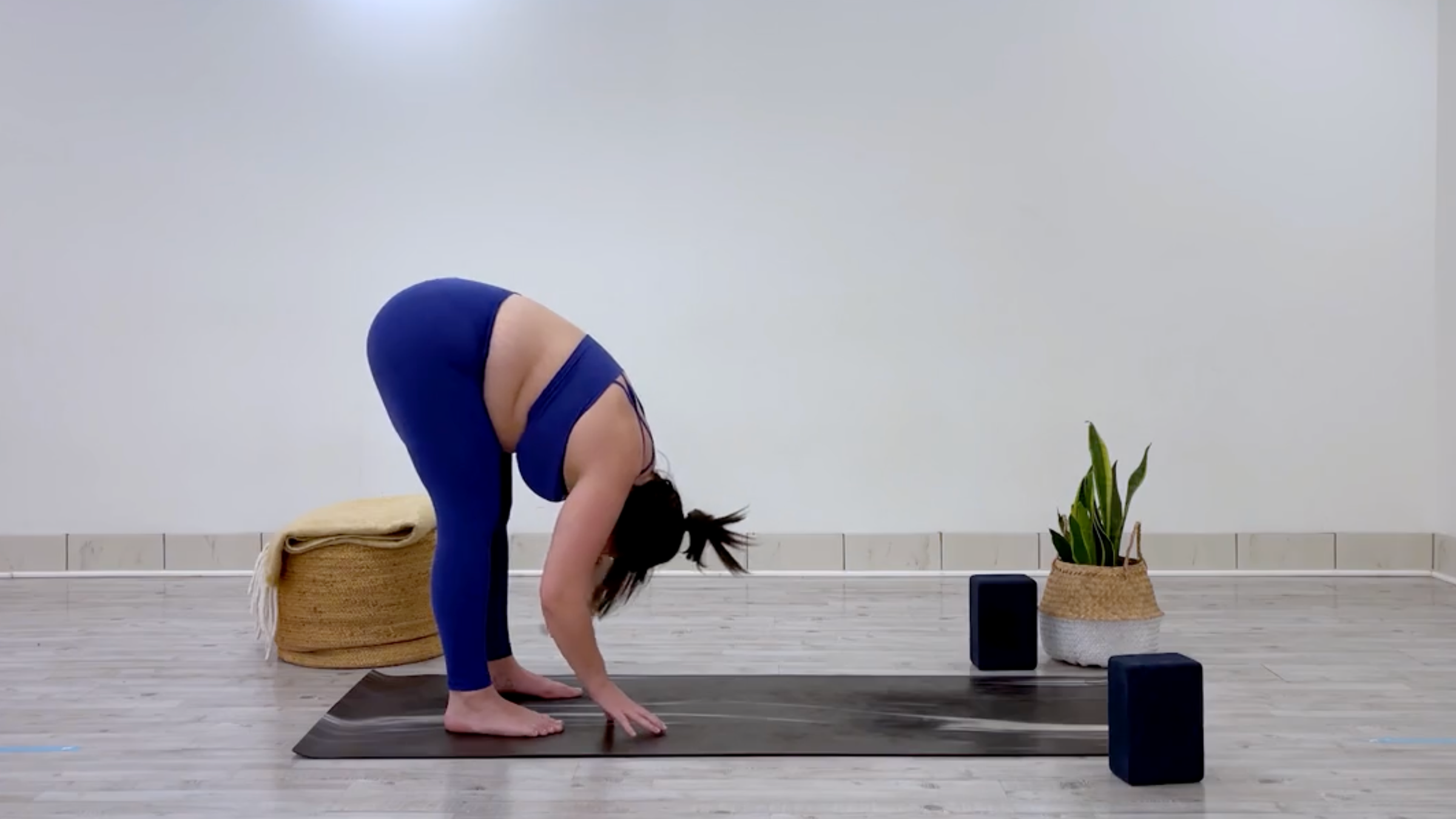 Teacher Taylor Lorenz in Standing Forward Bend