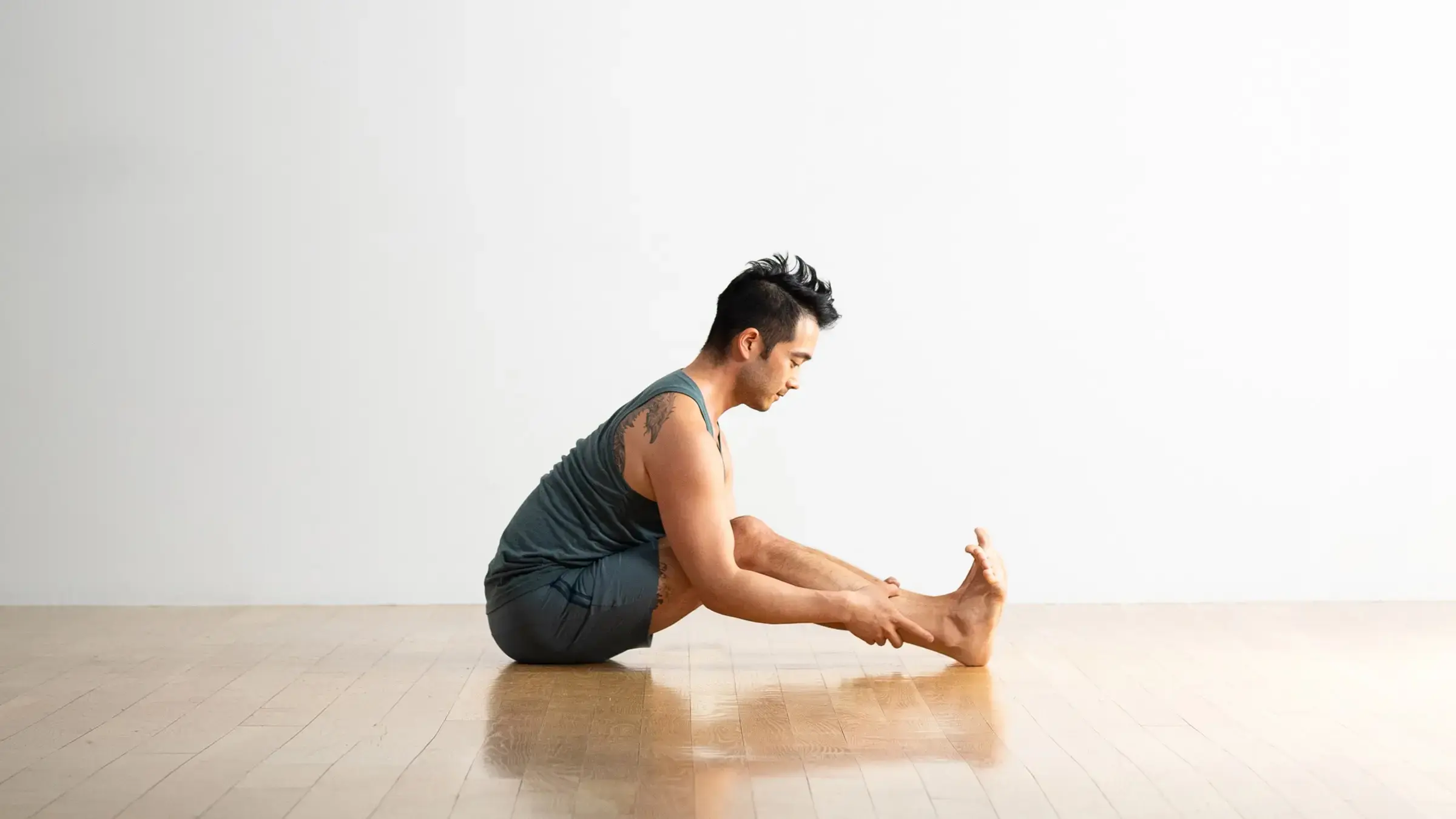 A man in Seated Forward Bend