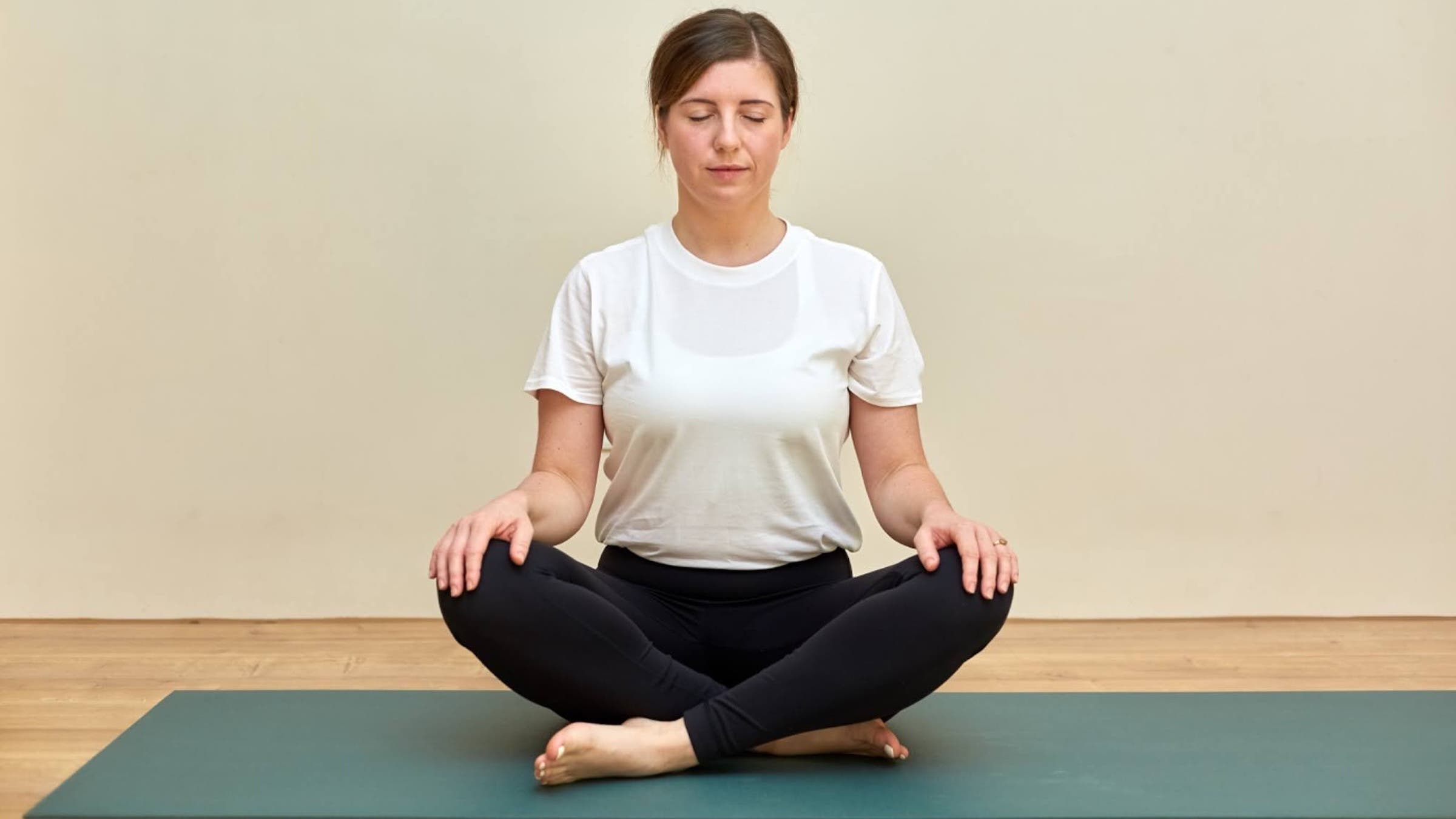 Yoga teacher Katie McGrath in Easy Pose, part of her yin yoga for back pain practice