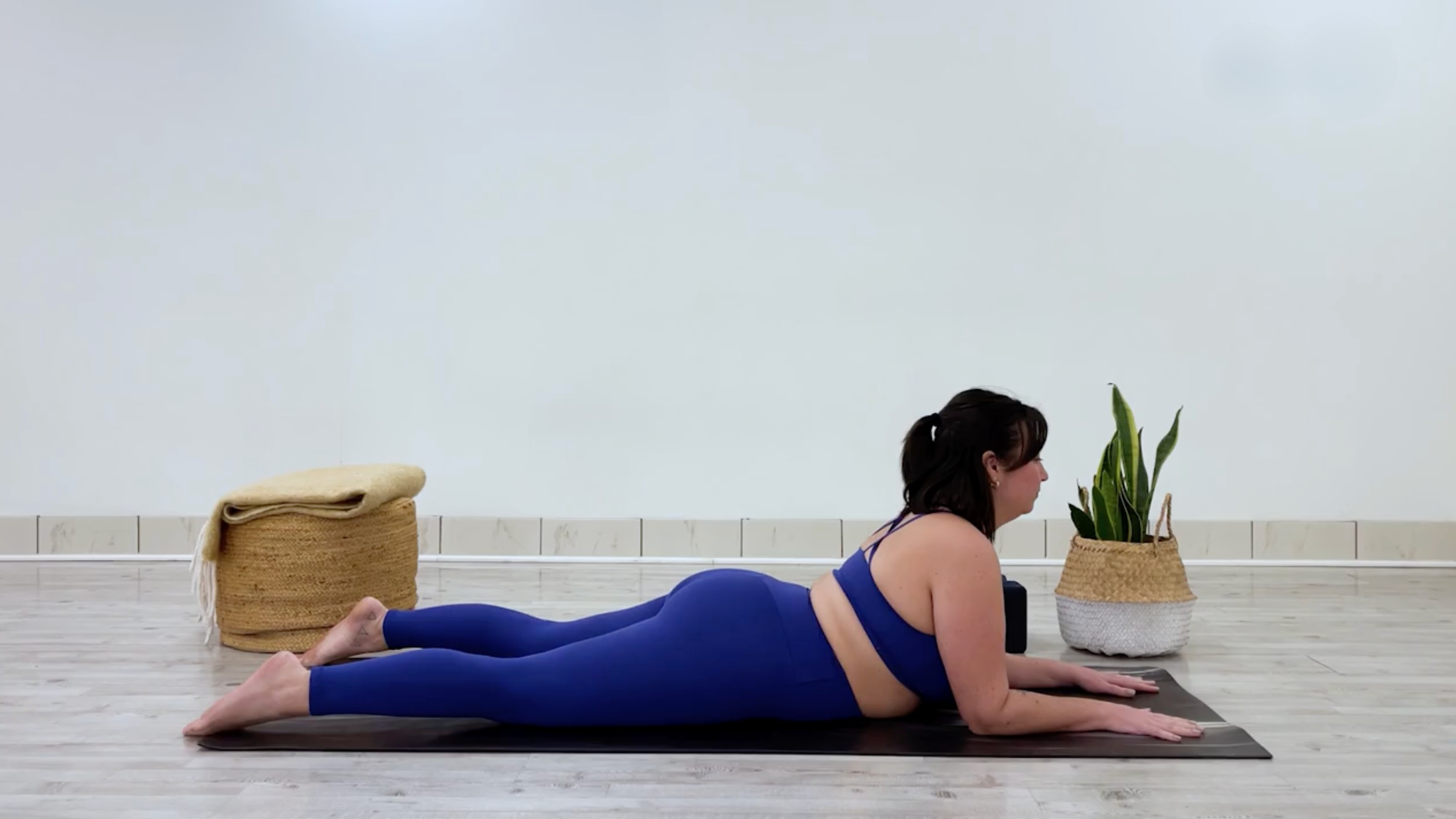 Yoga teacher Taylor Lorenz in Sphinx Pose, part of her yin yoga for tension practice