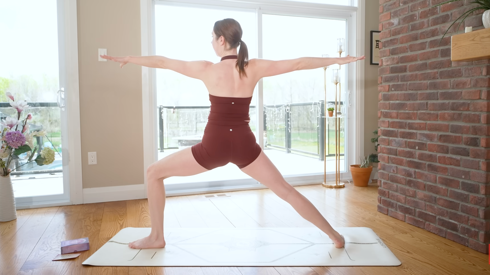 Woman standing on a mat in Warrior 2