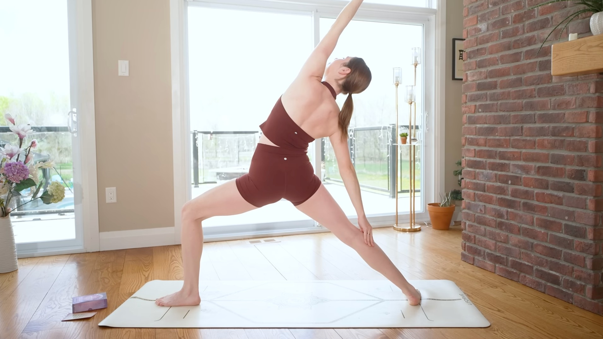 Yoga With Kassandra practicing Reverse Warrior during morning yoga