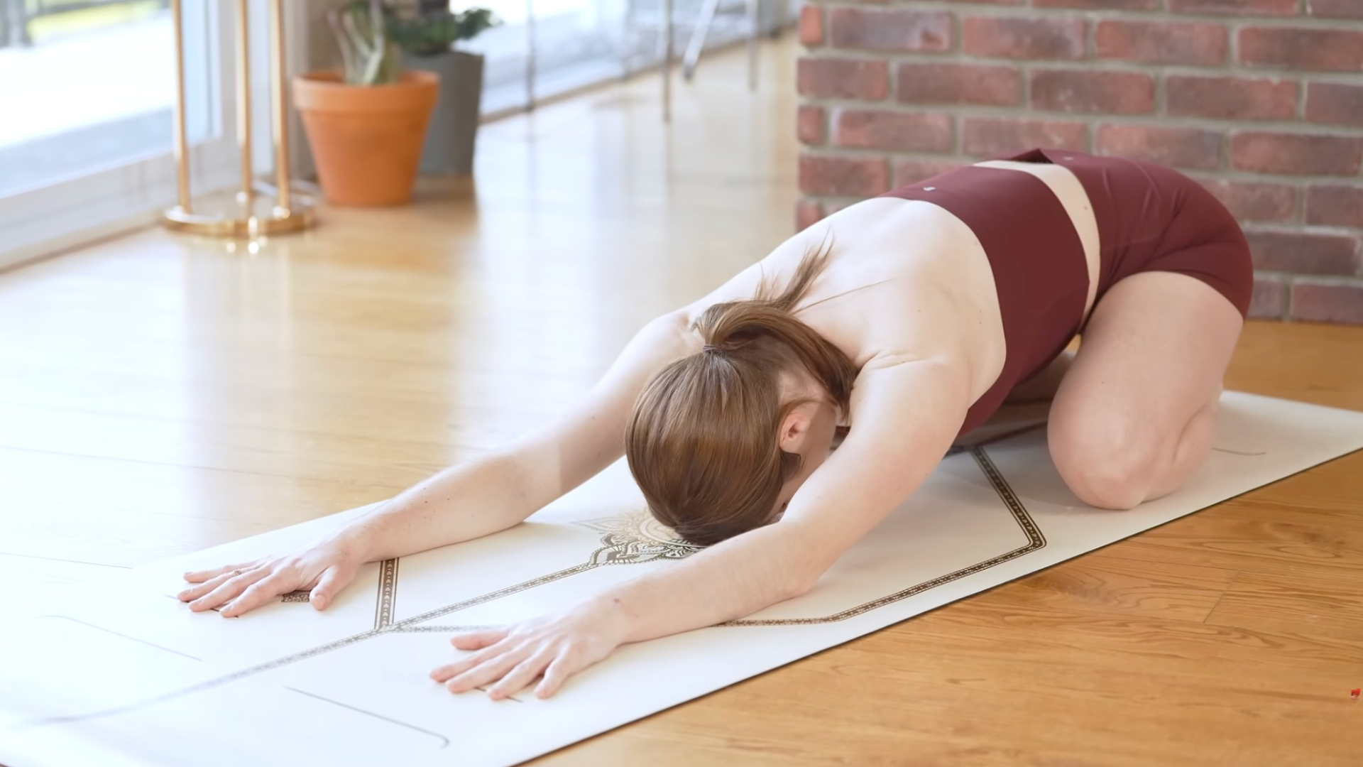 Woman kneeling back in Child's Pose while following through on intention setting