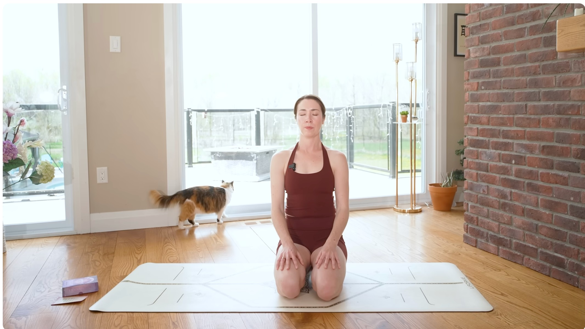 Woman kneeling and sitting back on her heels following a morning yoga routine for intention setting