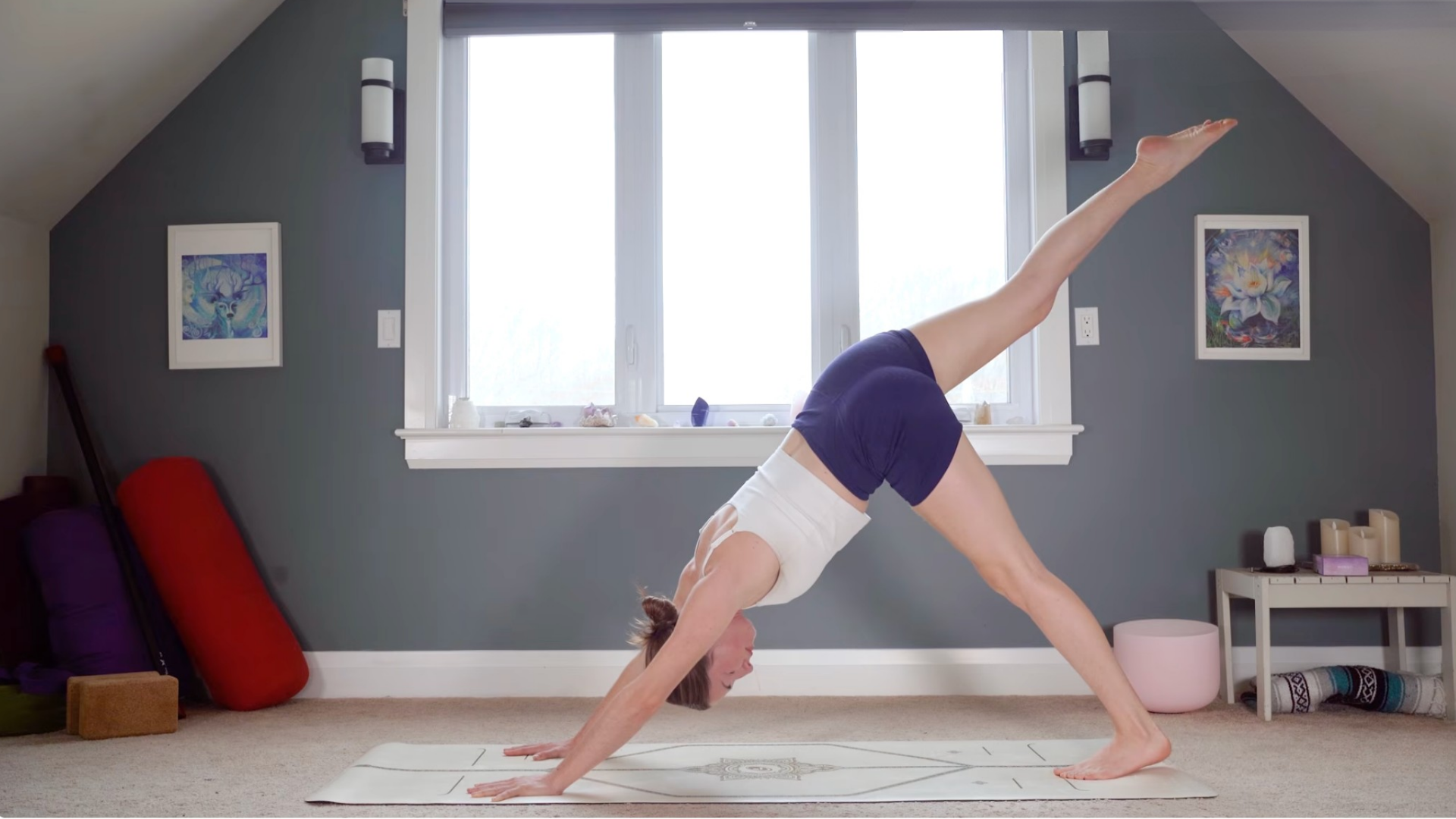Woman lifting her right leg from Downward-Facing Dog during a yoga flow