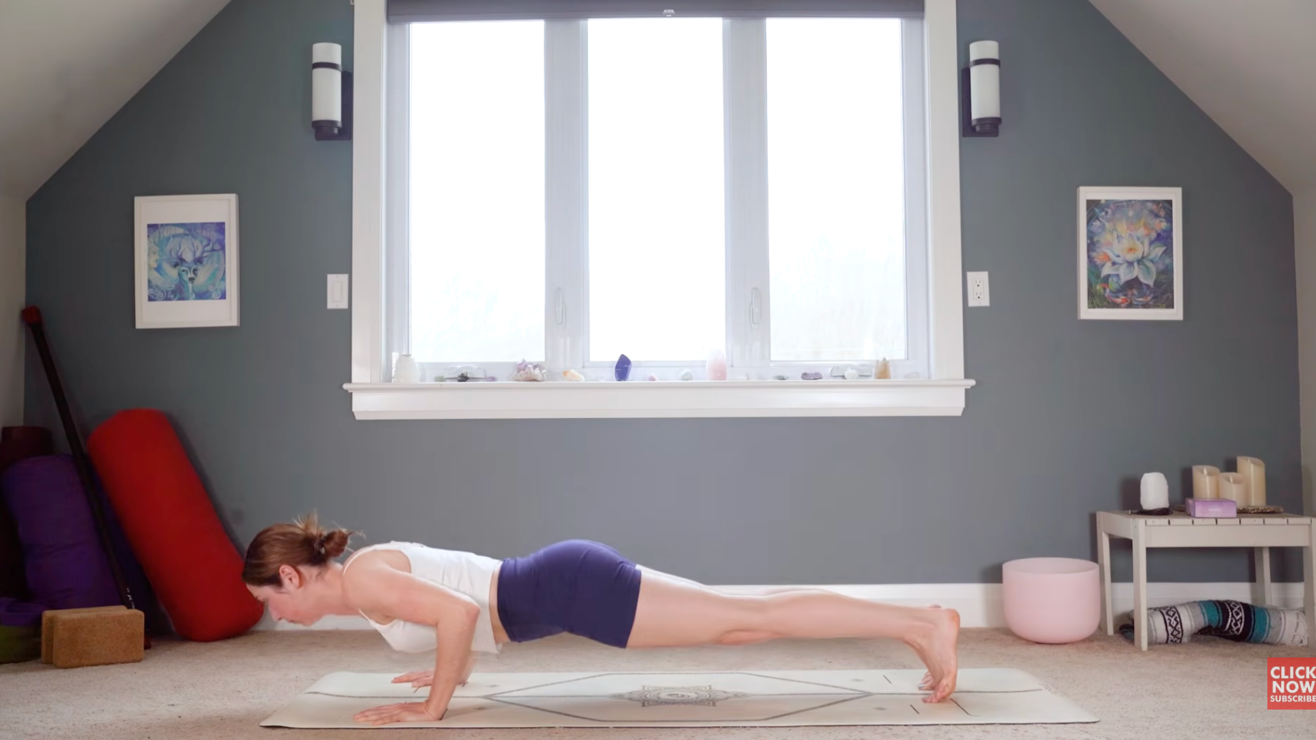 Woman lowering herself from Plank Pose or top of a push-up into Chaturanga with her elbows bent