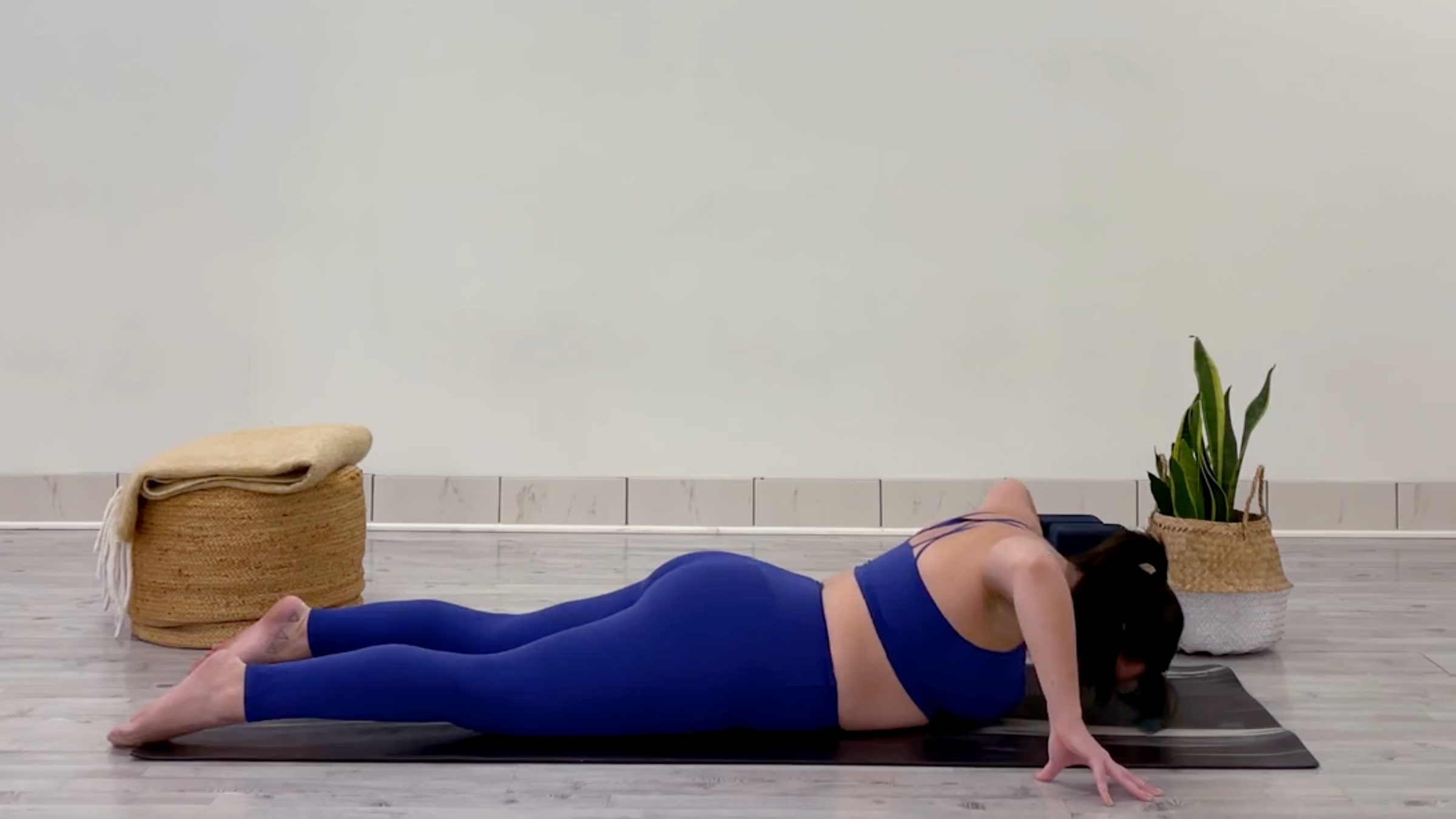 Yoga teacher Taylor Lorenz in Cobra Pose, part of her 15 minute yoga flow for a full body stretch