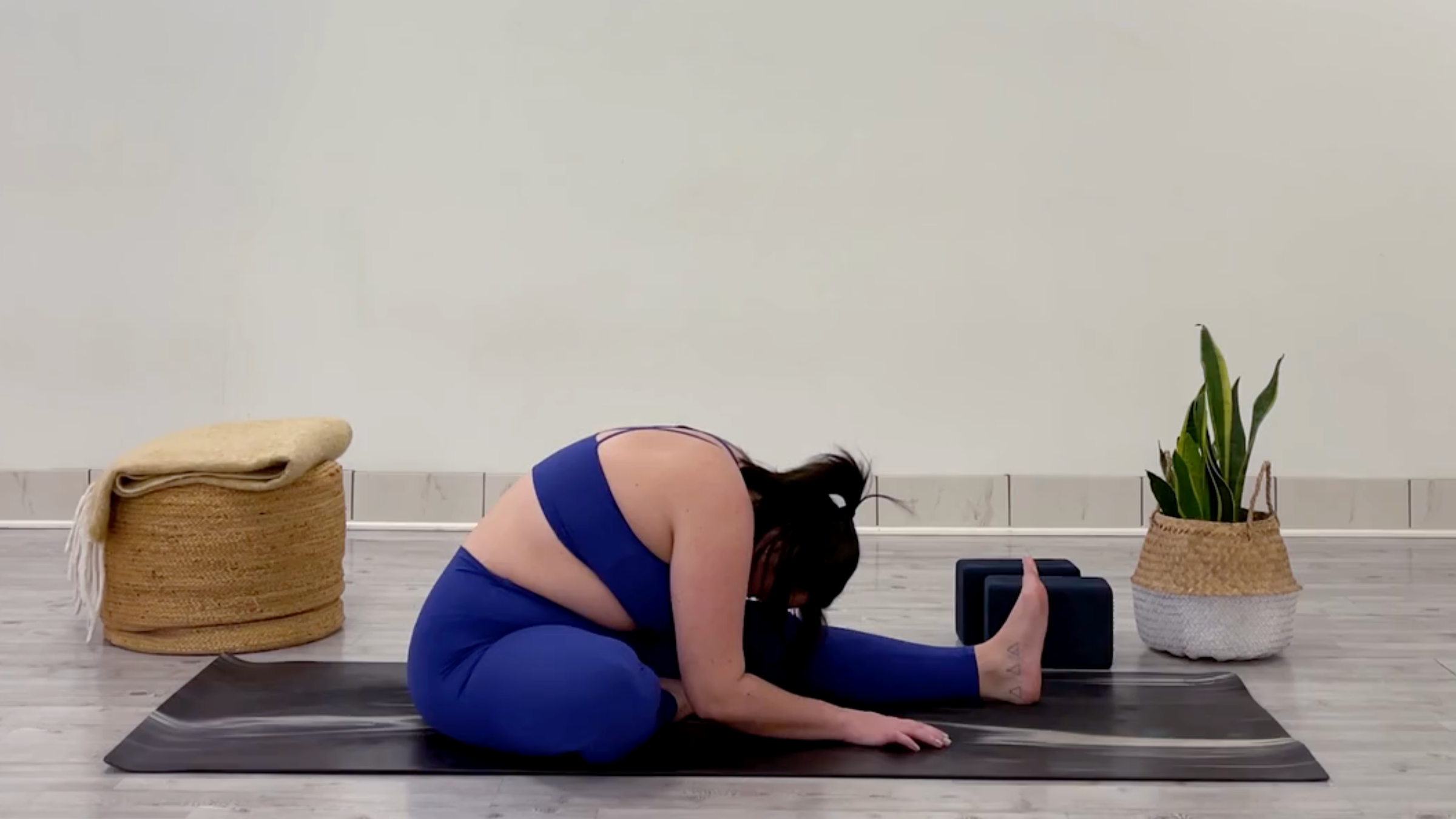 Yoga teacher Taylor Lorenz in Head-to-Knee Forward Bend