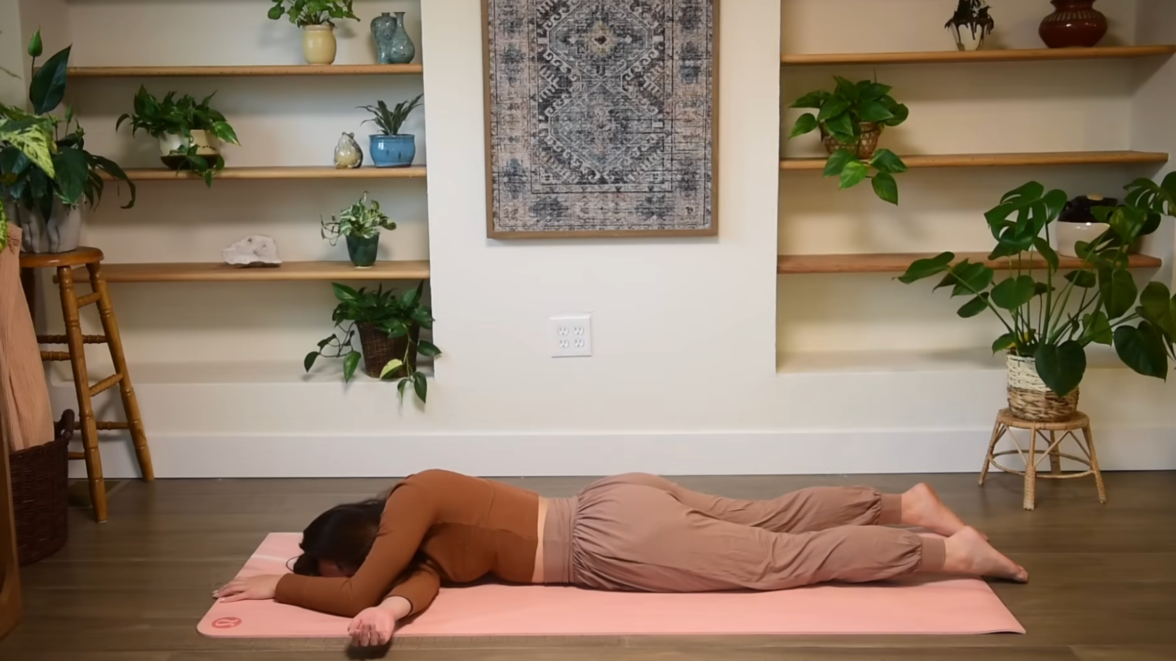 Yoga teacher practicing Prone Thread the Needle.