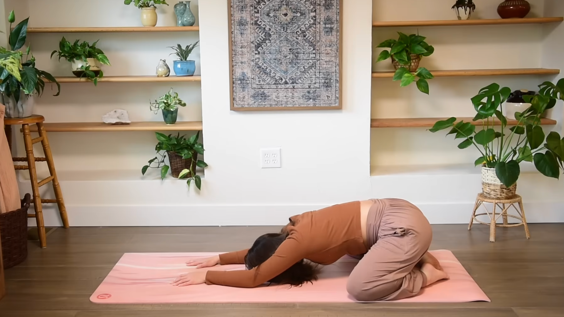 Yoga teacher practicing Child's Pose.