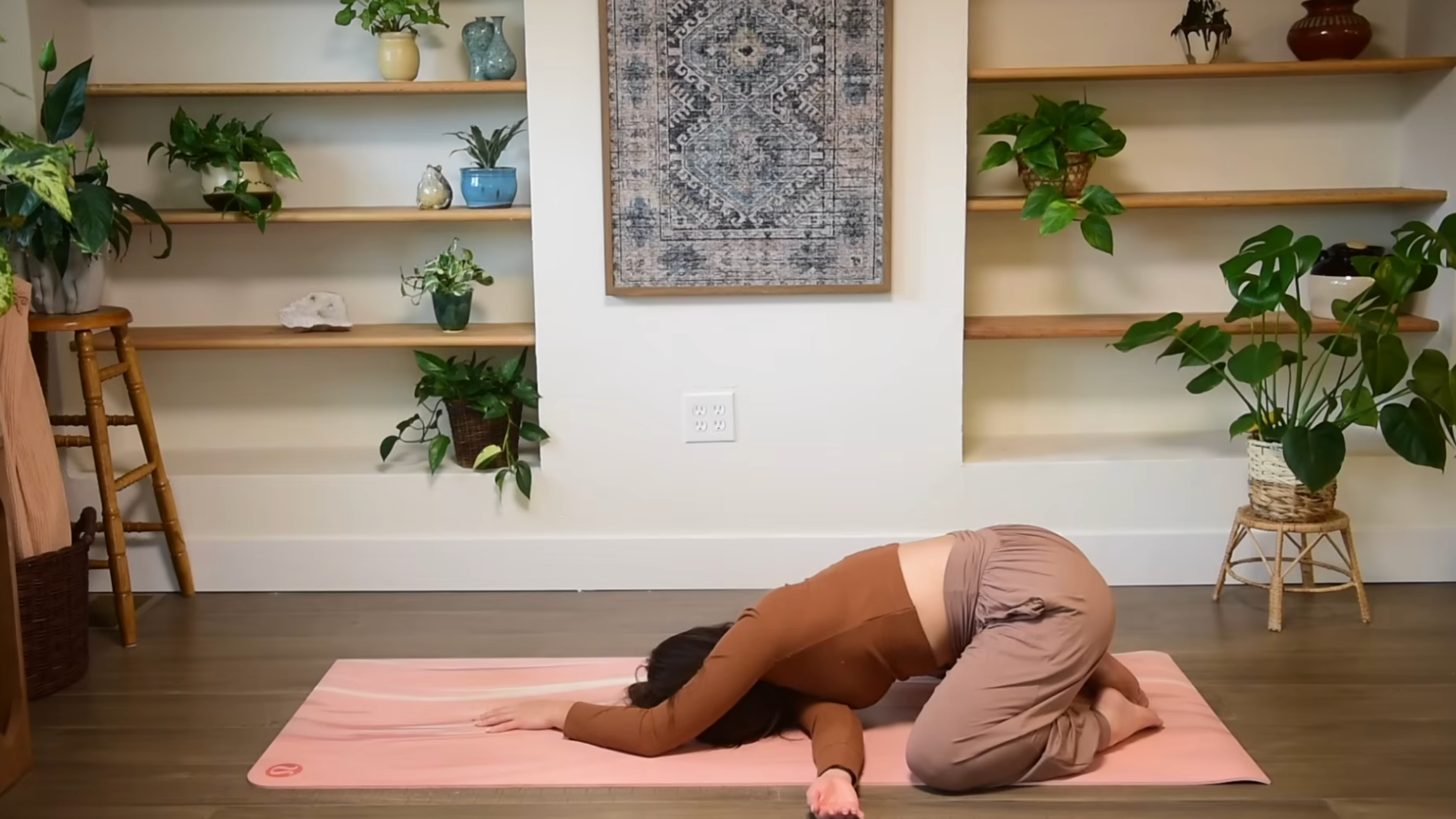 Yoga teacher practicing child's pose using needle thread.