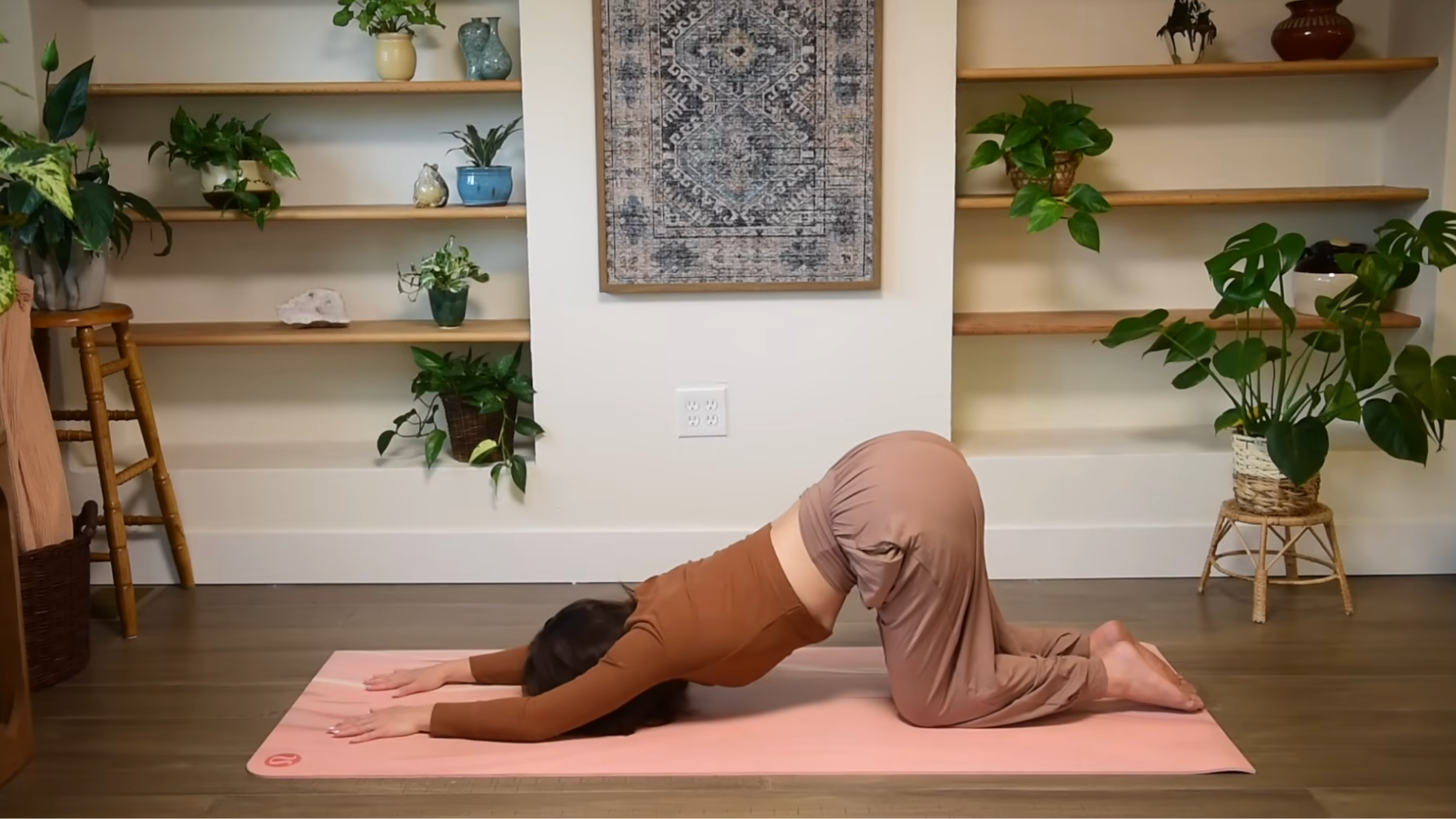 Yoga teacher practicing Puppy Pose.