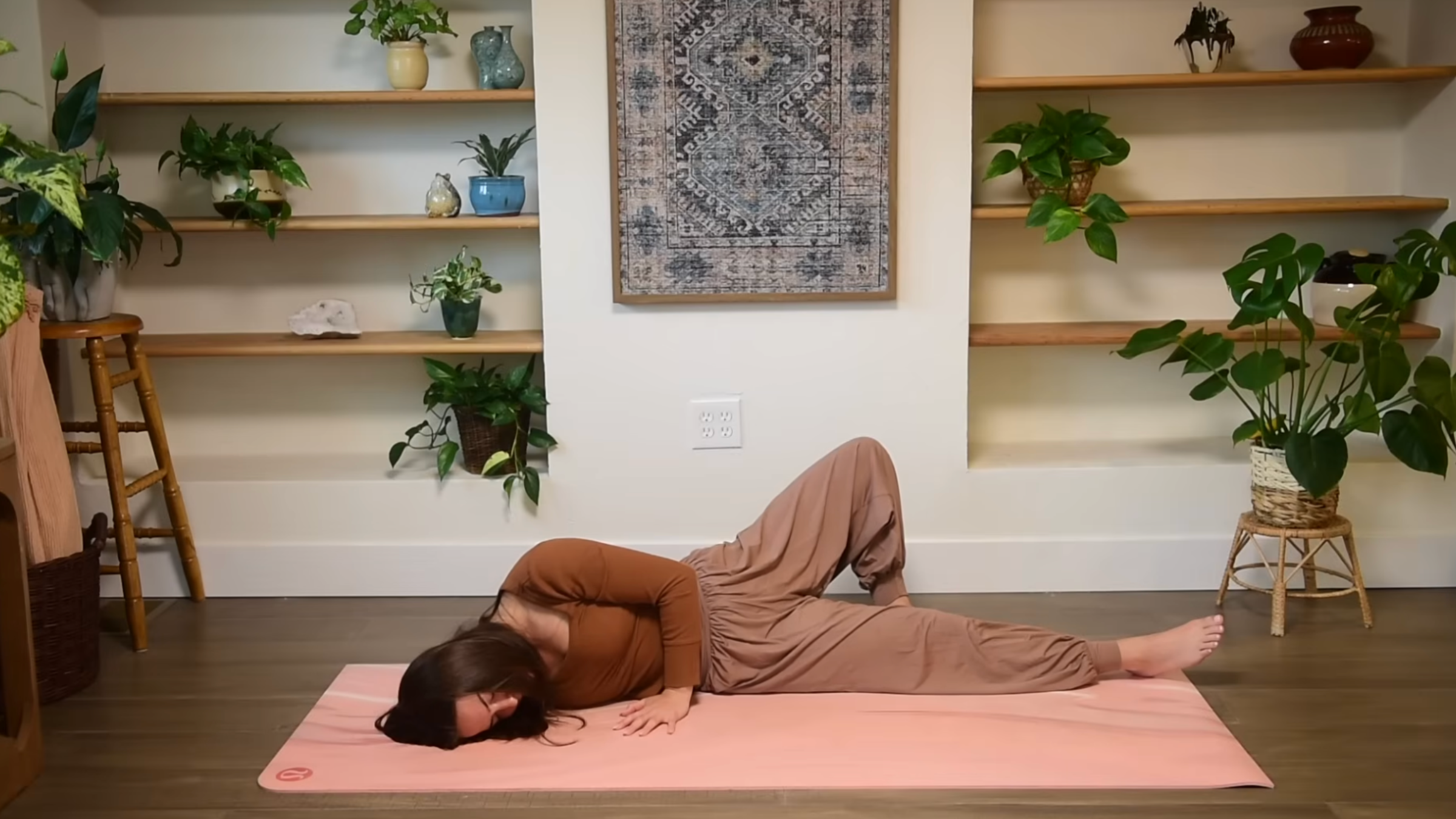 Yoga teacher practicing Broken Wing.