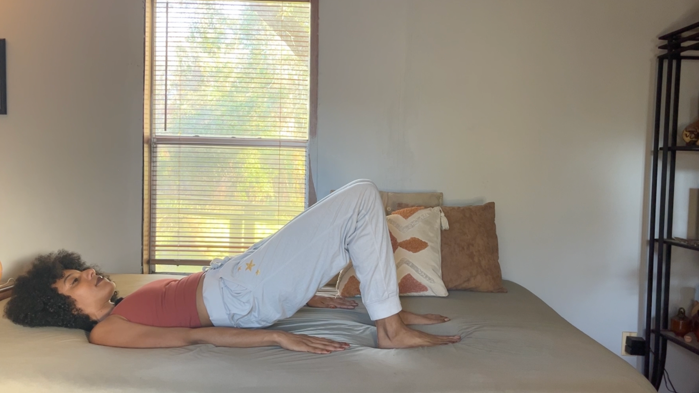 Yoga teacher practicing Bridge Pose.
