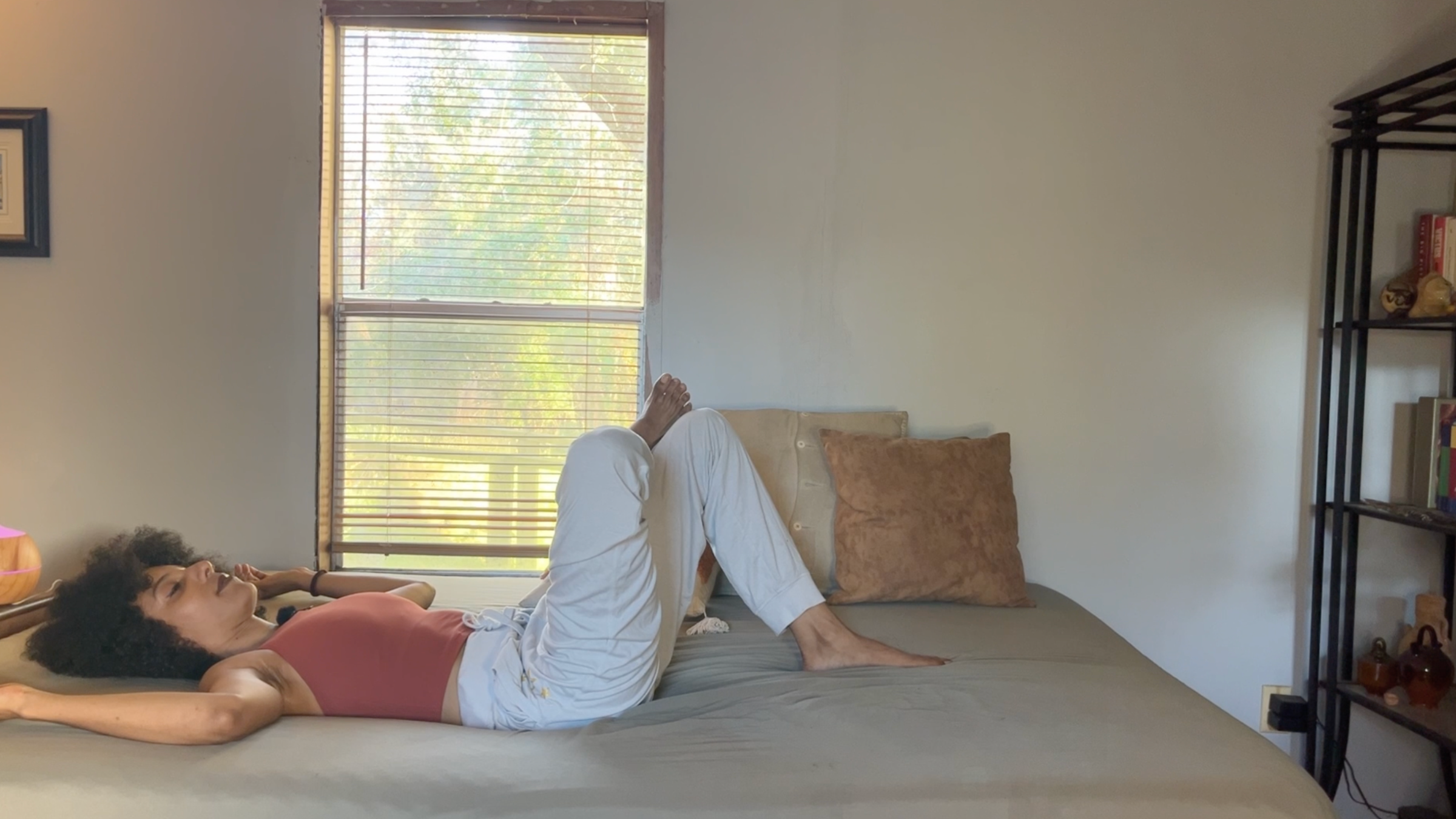 Yoga teacher practicing Figure 4 stretch.