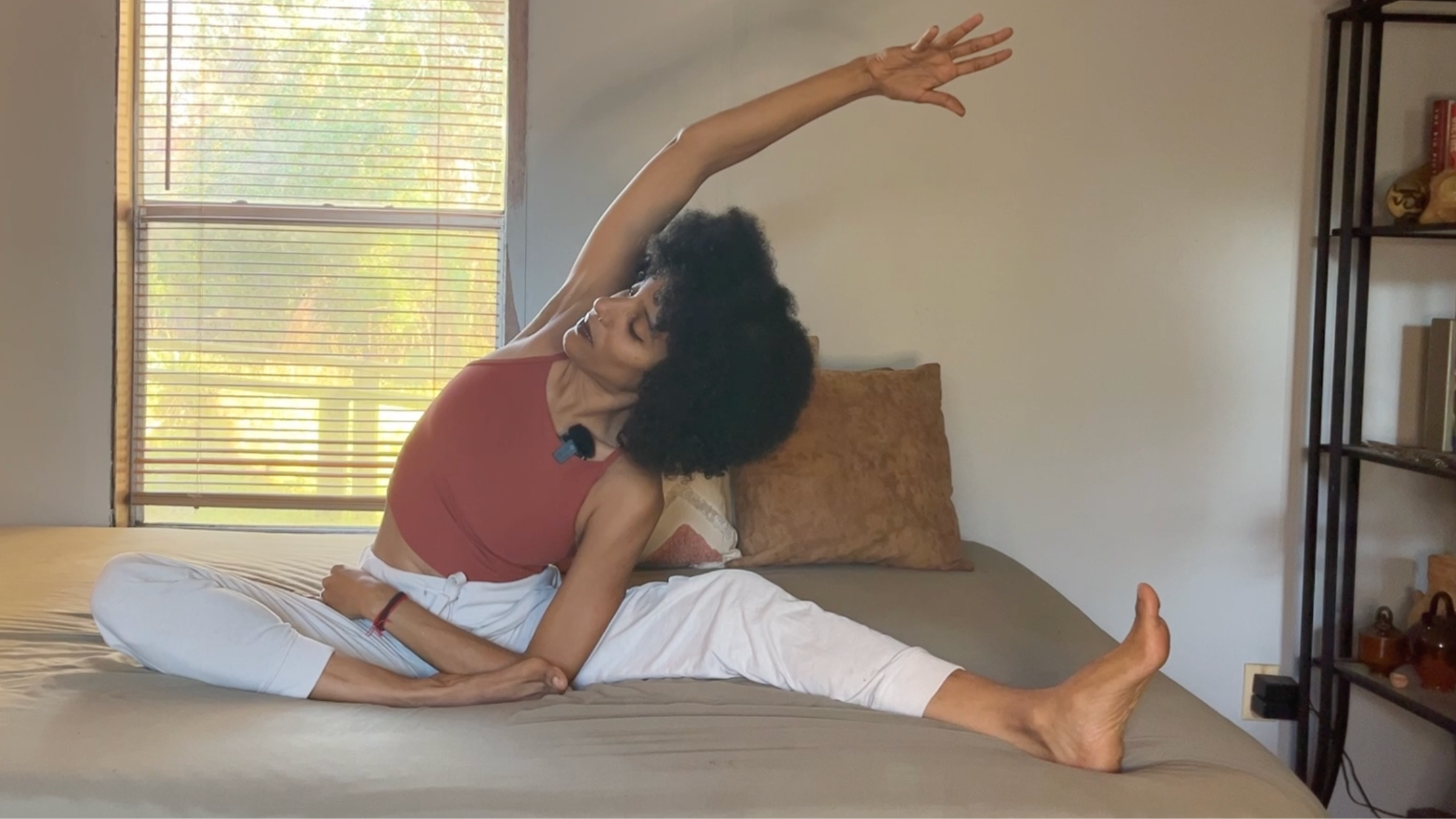 Yoga teacher practicing Revolved Head to Knee Pose.