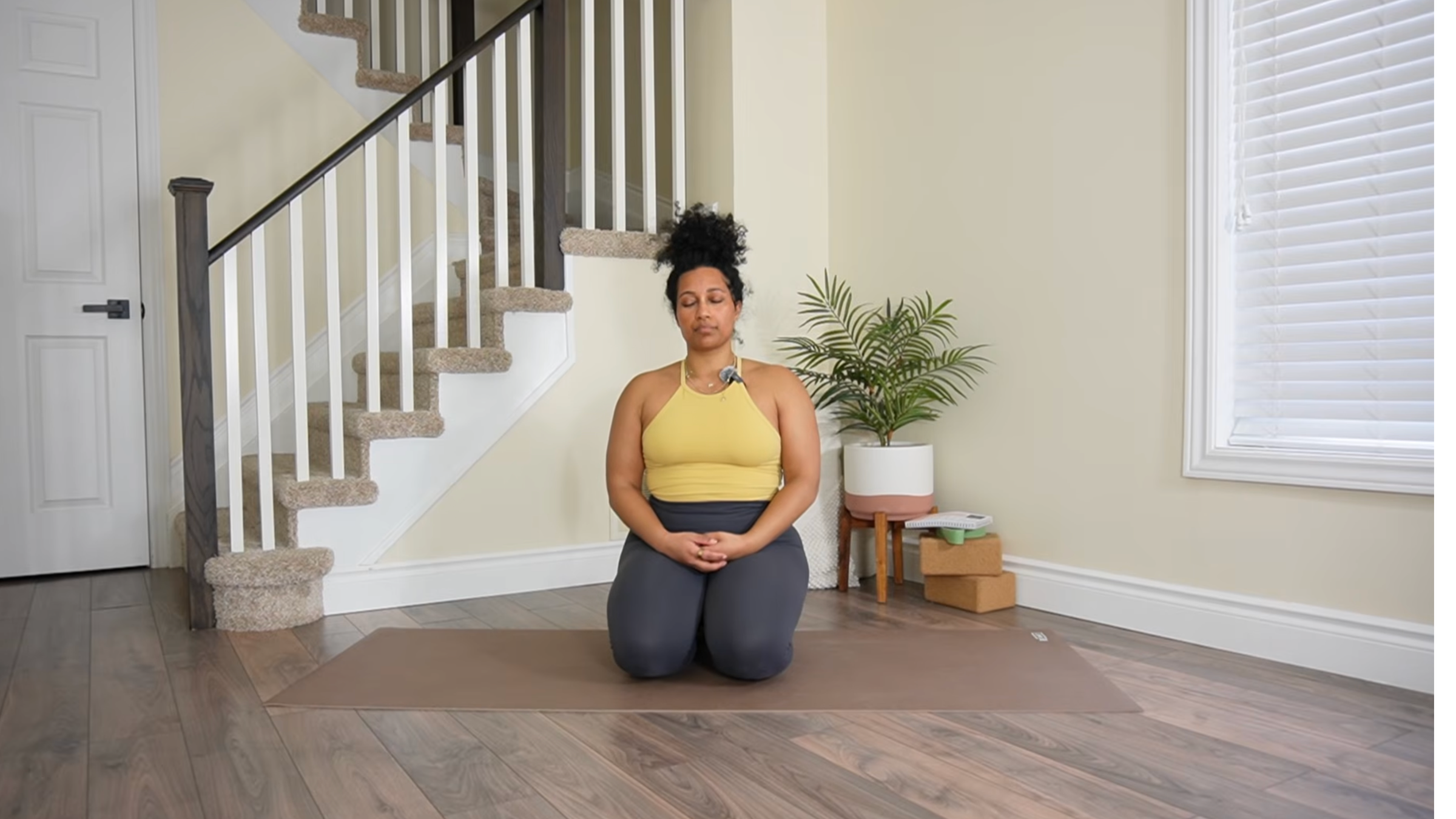 Yoga teacher practicing Shoulder Rolls.
