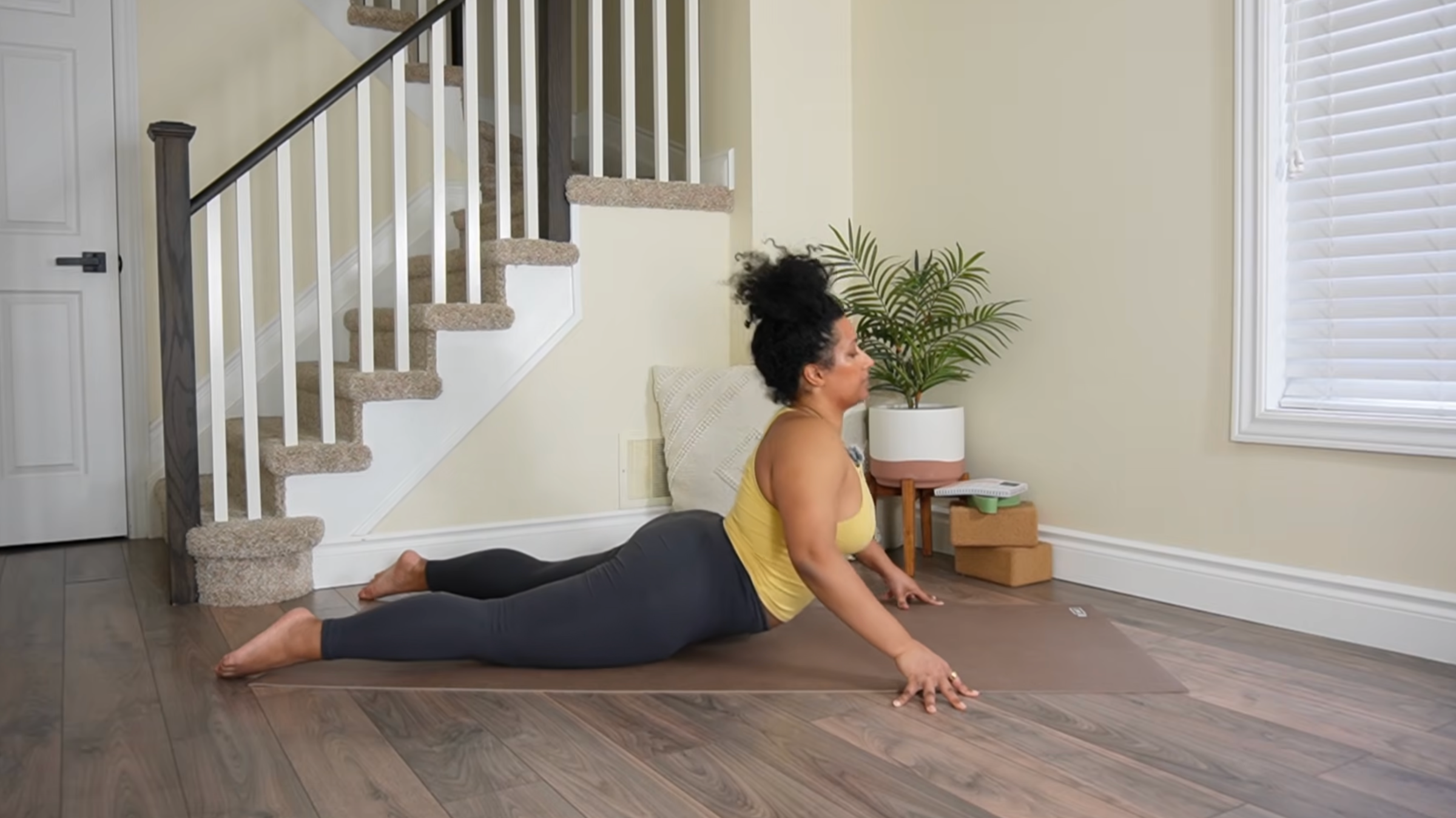 Yoga teacher practicing Cobra lifts.