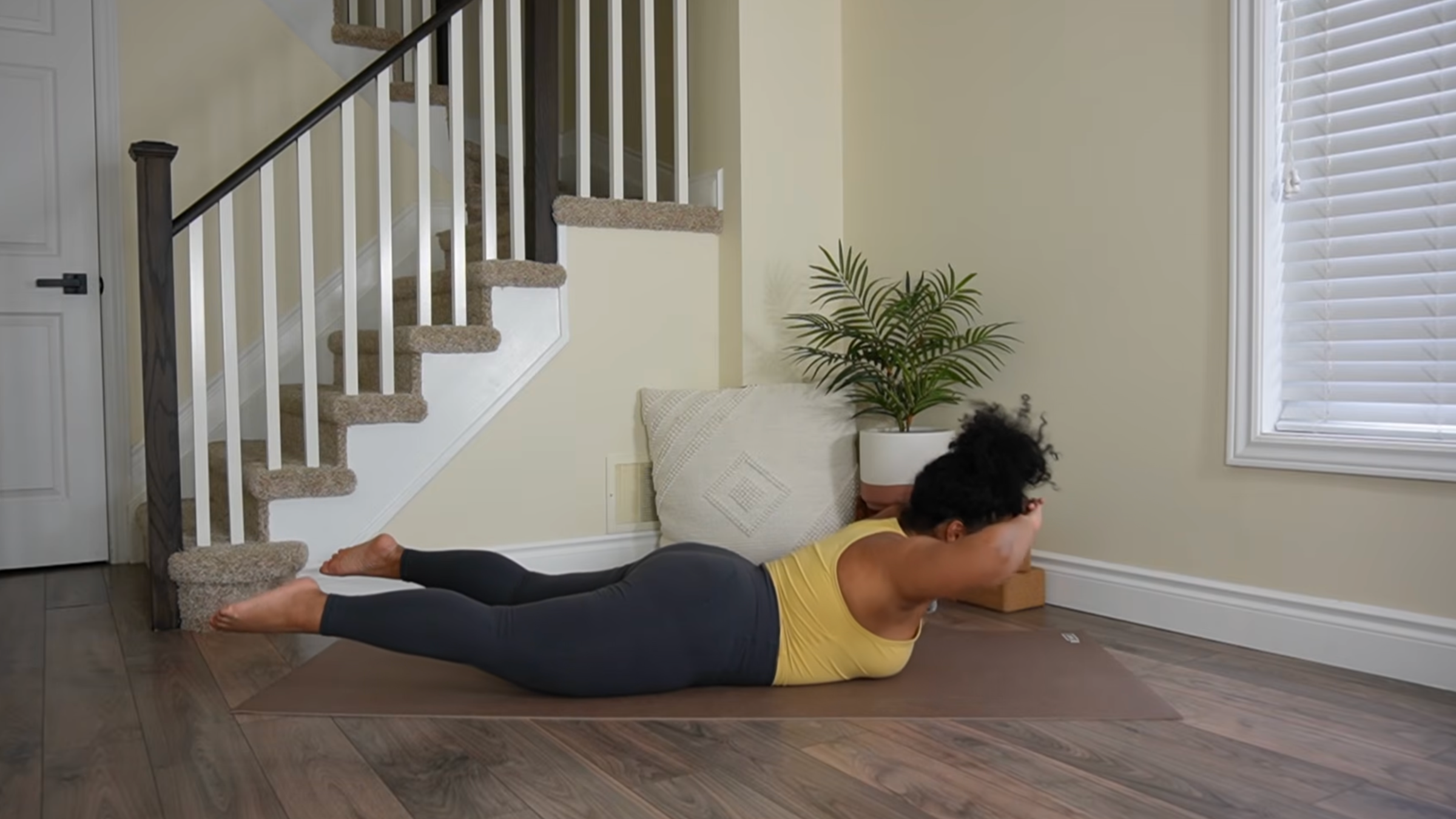 Yoga teacher practicing Locust Pose lifts.