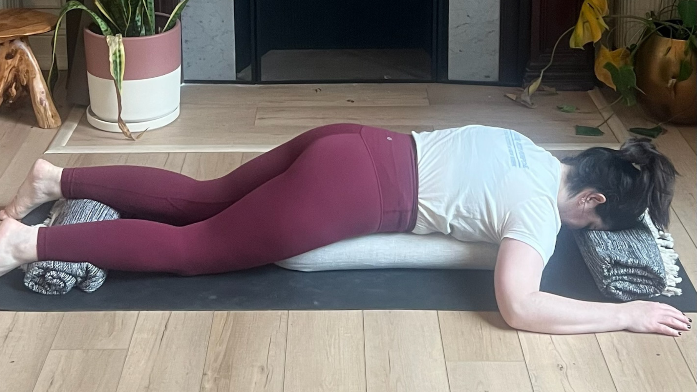 Woman practicing Prone Savasana.