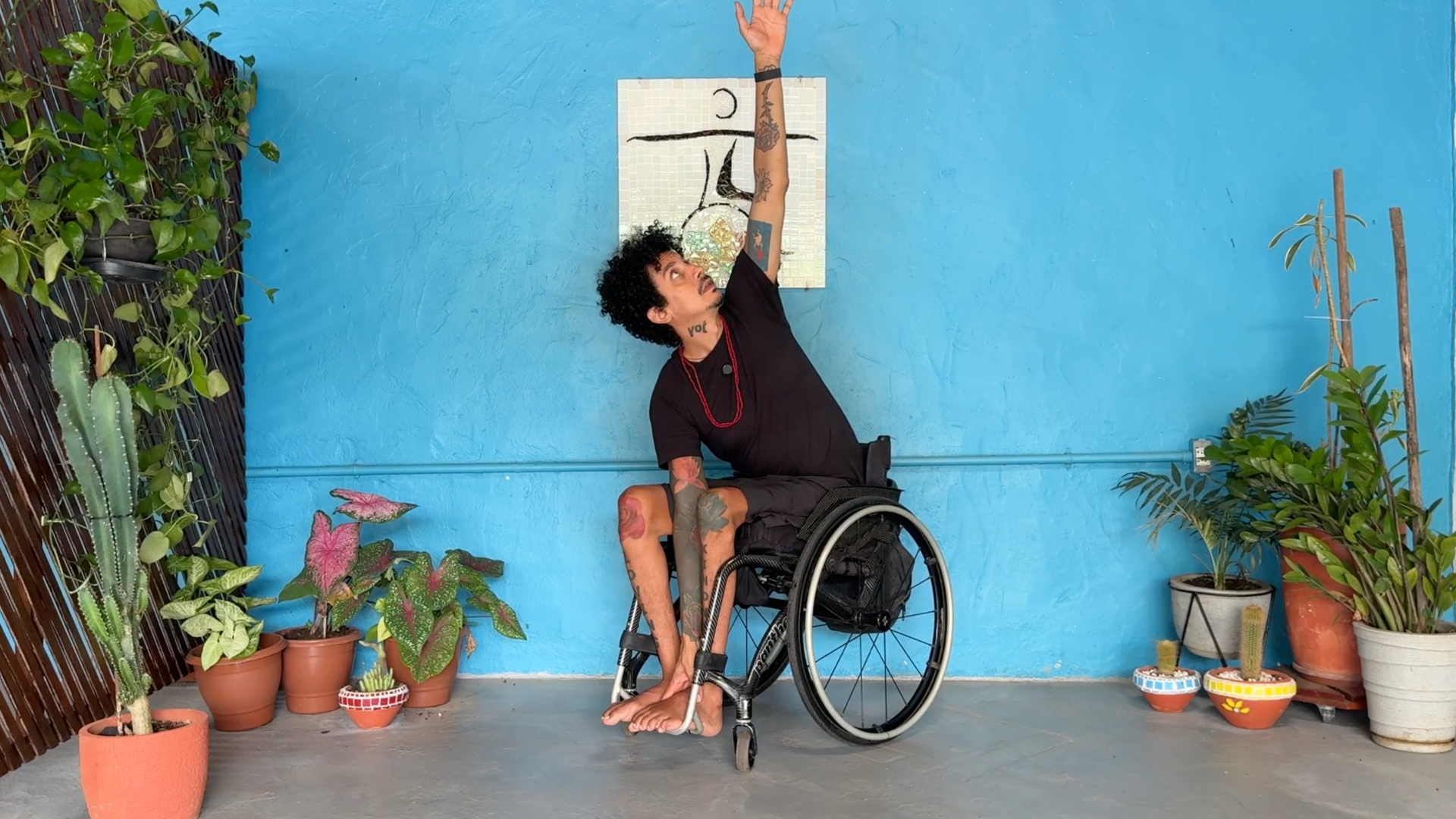 Yoga teacher Rodrigo Souza practicing a chair yoga version of Triangle Pose