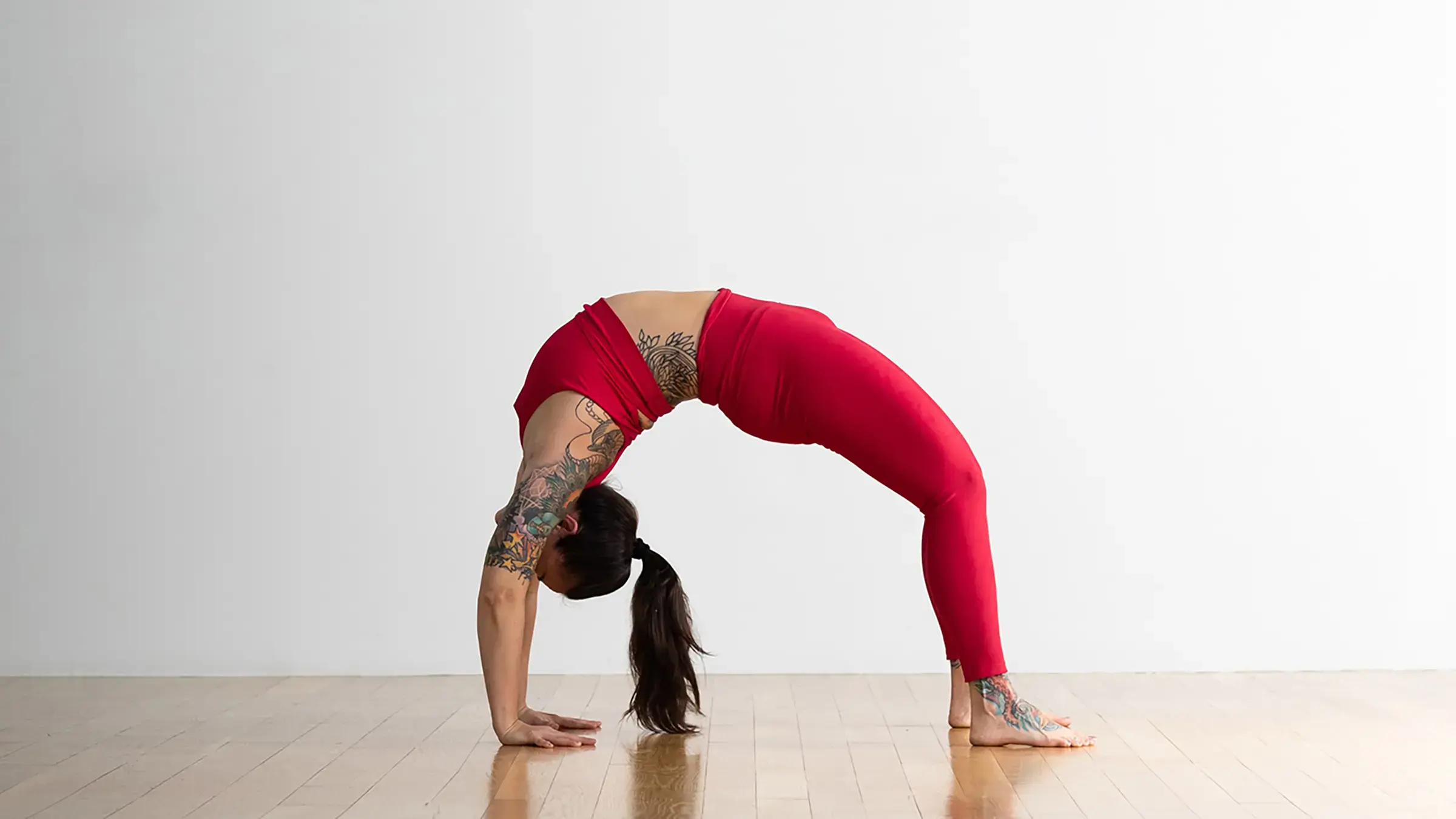 A woman in Wheel Pose, a shape that builds core strength