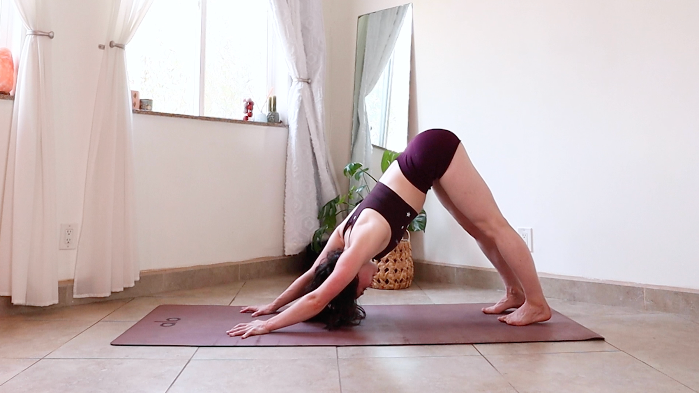 Yoga teacher Daria LeGrand wears downward facing dog, part of her yoga practice to reset the mind and body
