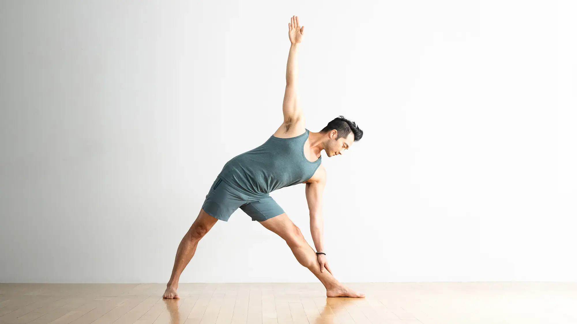 A woman in Triangle Pose, a pose that protects your lower back