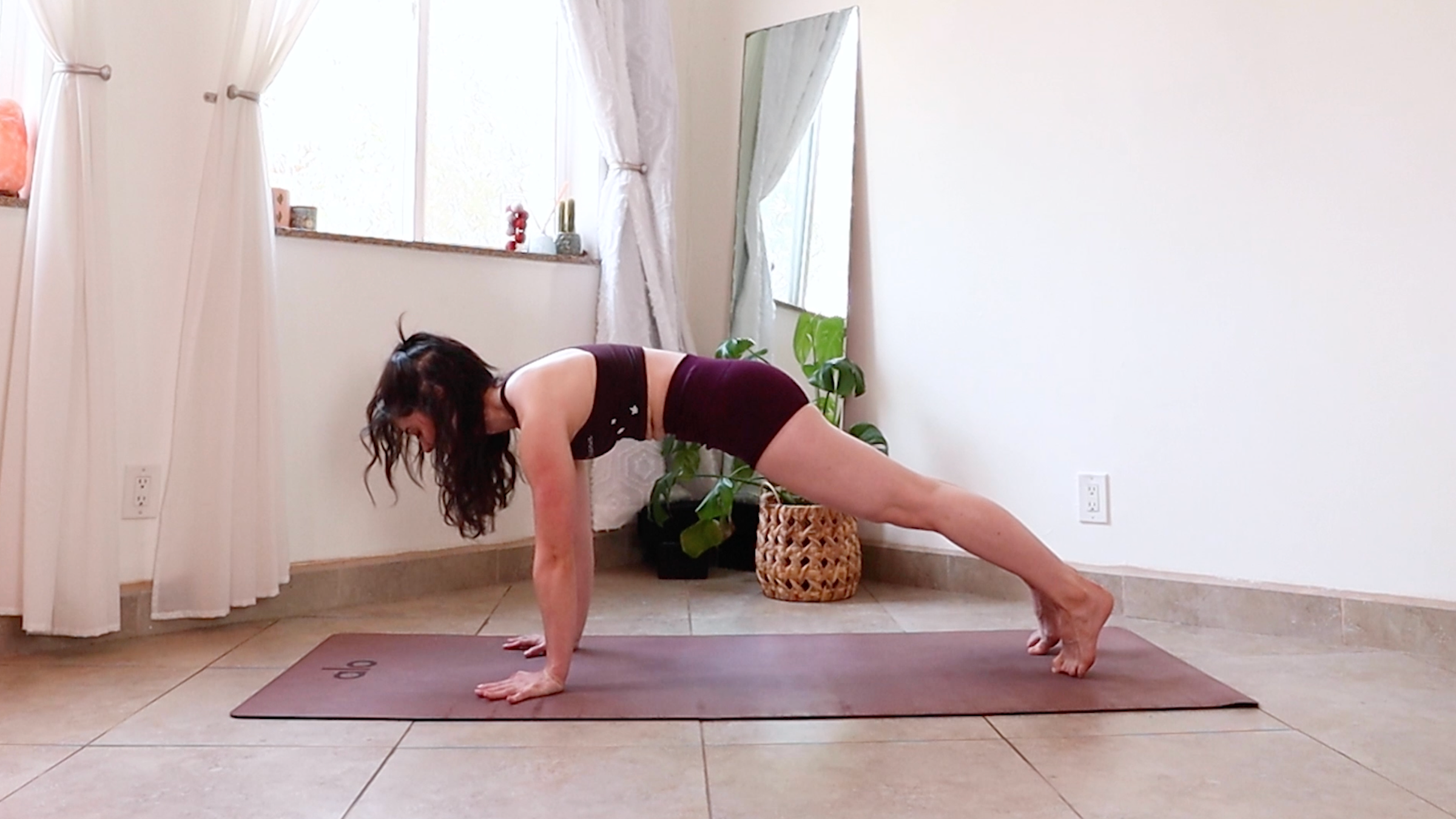 Yoga teacher Daria LeGrand performs the high plank exercise