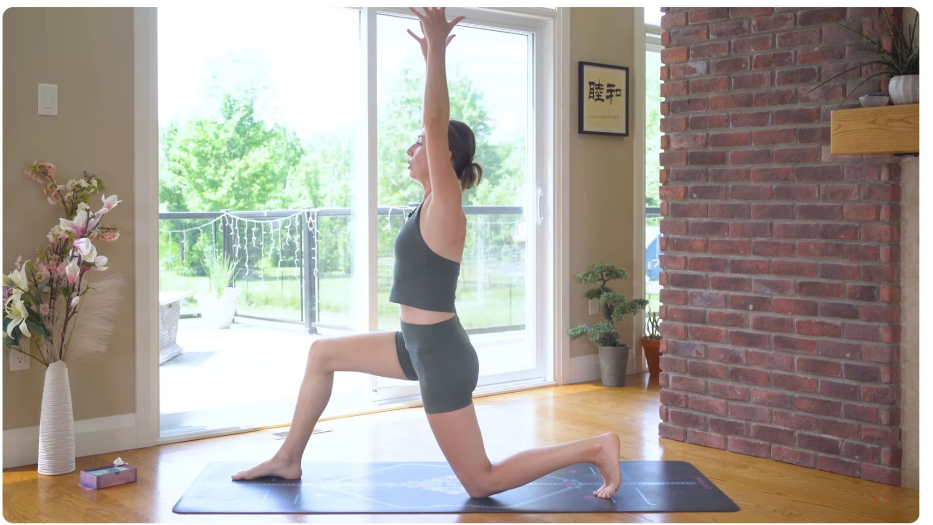 Woman kneeling on a yoga mat in Low Lunge or Anjaneyasana