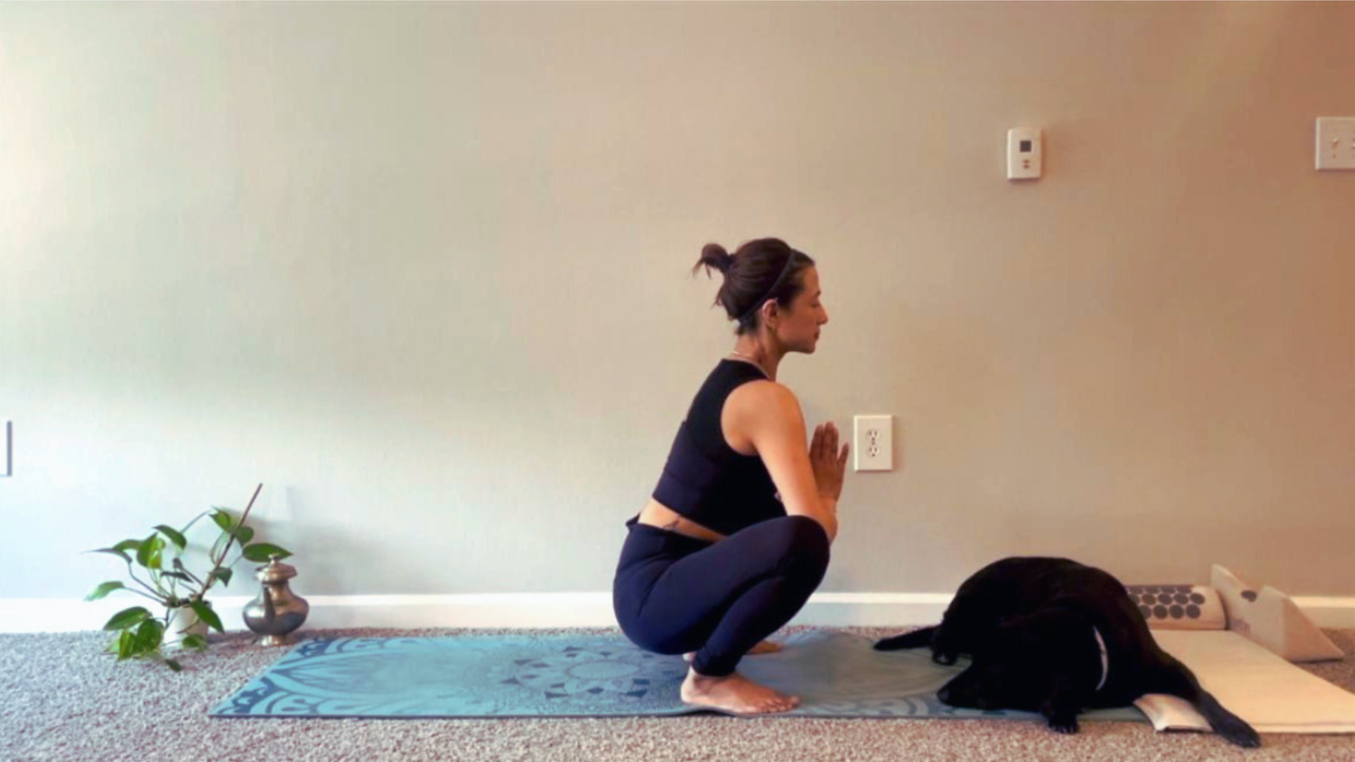 Woman practicing Squat Pose to lengthen the lower back and stretch the pelvic floor muscles during a yoga for lower back pain relief practice