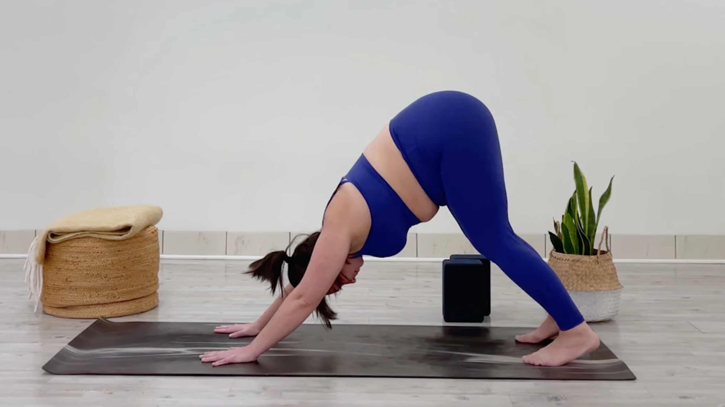 Yoga teacher Taylor Lorenz in Downward-Facing Dog, part of her morning yoga for tension flow