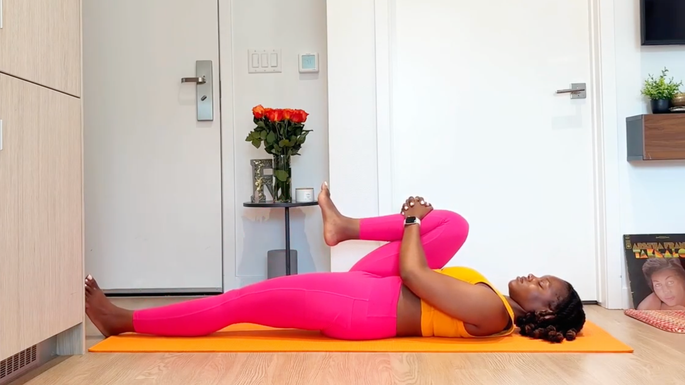 Yoga teacher practicing Knee to Chest 