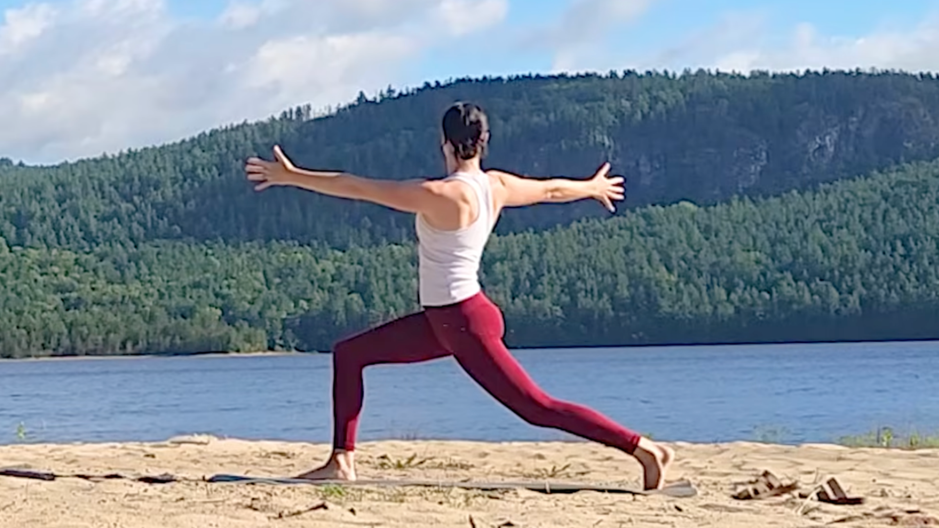 Woman standing in High Lunge while twisting toward the right