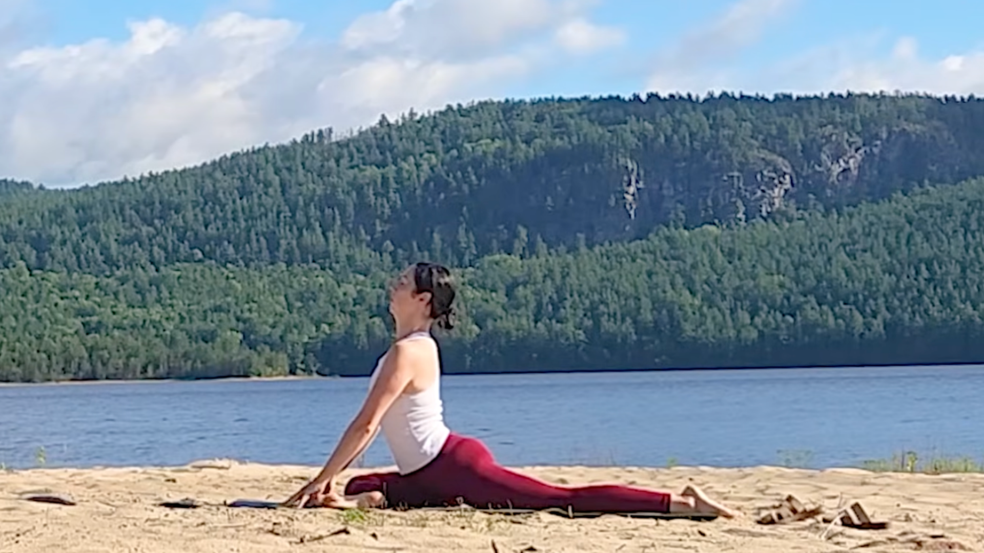 Woman on a yoga mat in Pigeon Pose