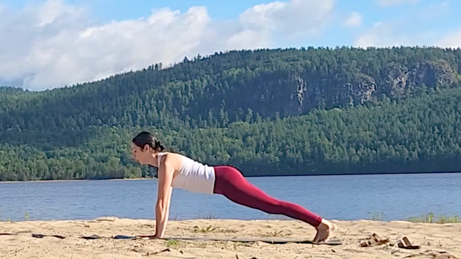 Woman in Plank Pose or High Push-Up during a 15-minute yoga routine
