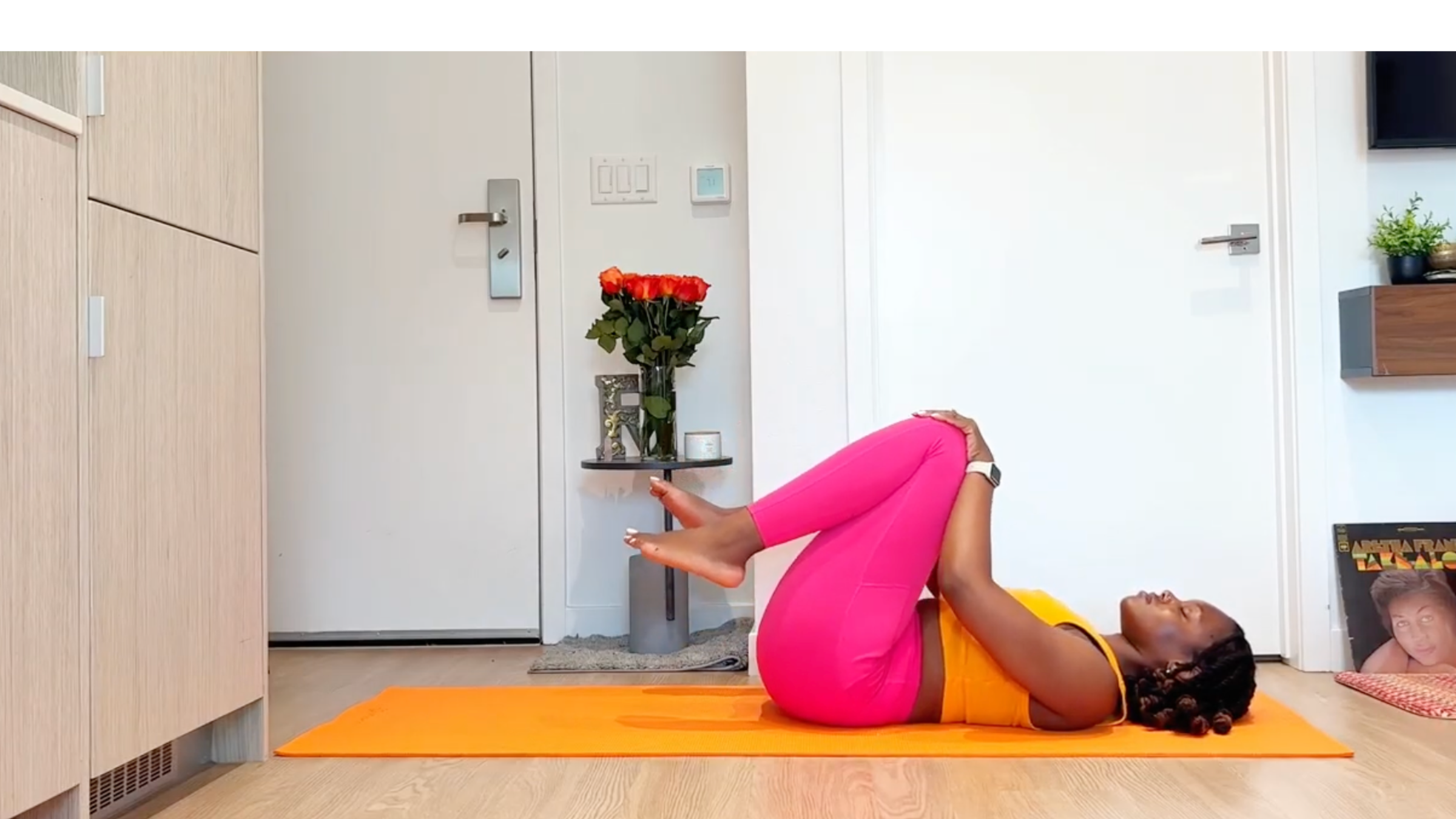 Yoga teacher practicing knee circles.