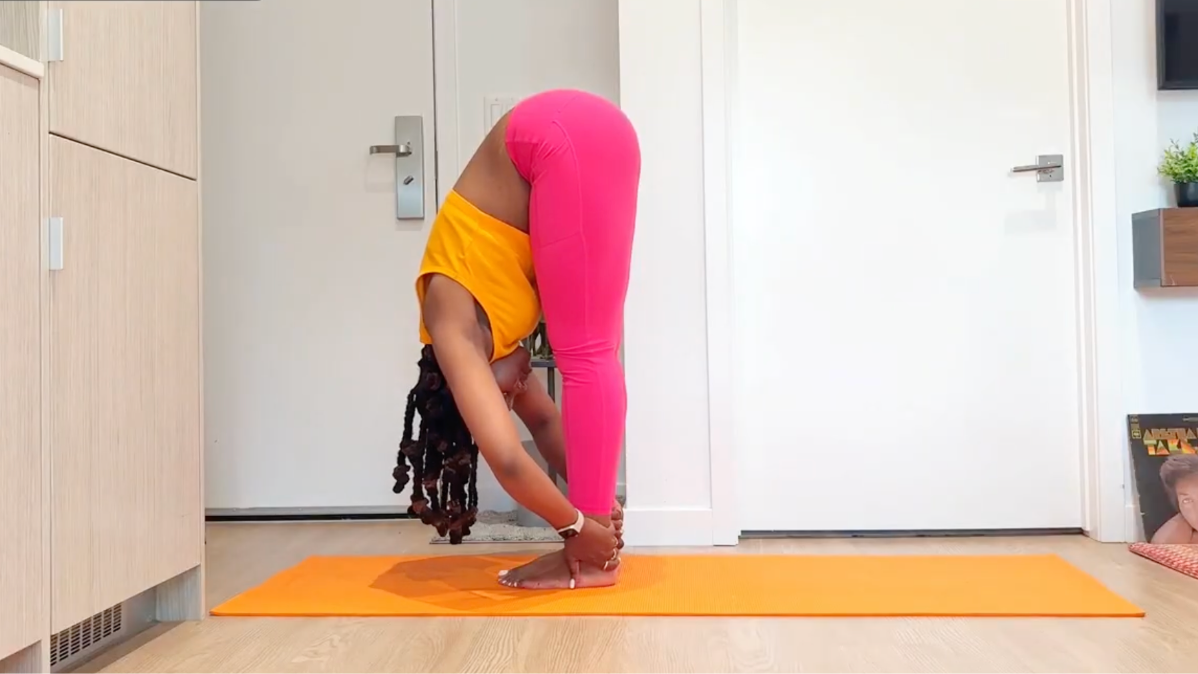 Yoga teacher practicing Standing Forward Bend