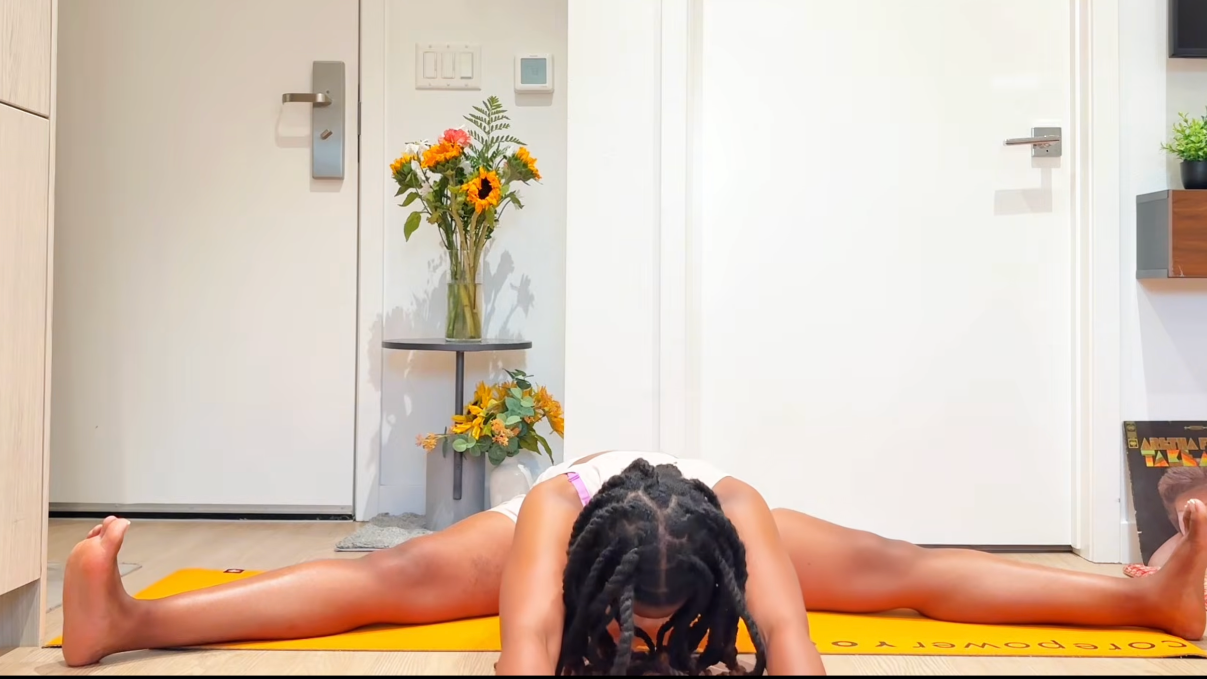 Yoga teacher practicing Wide-Legged Seated Forward Bend.