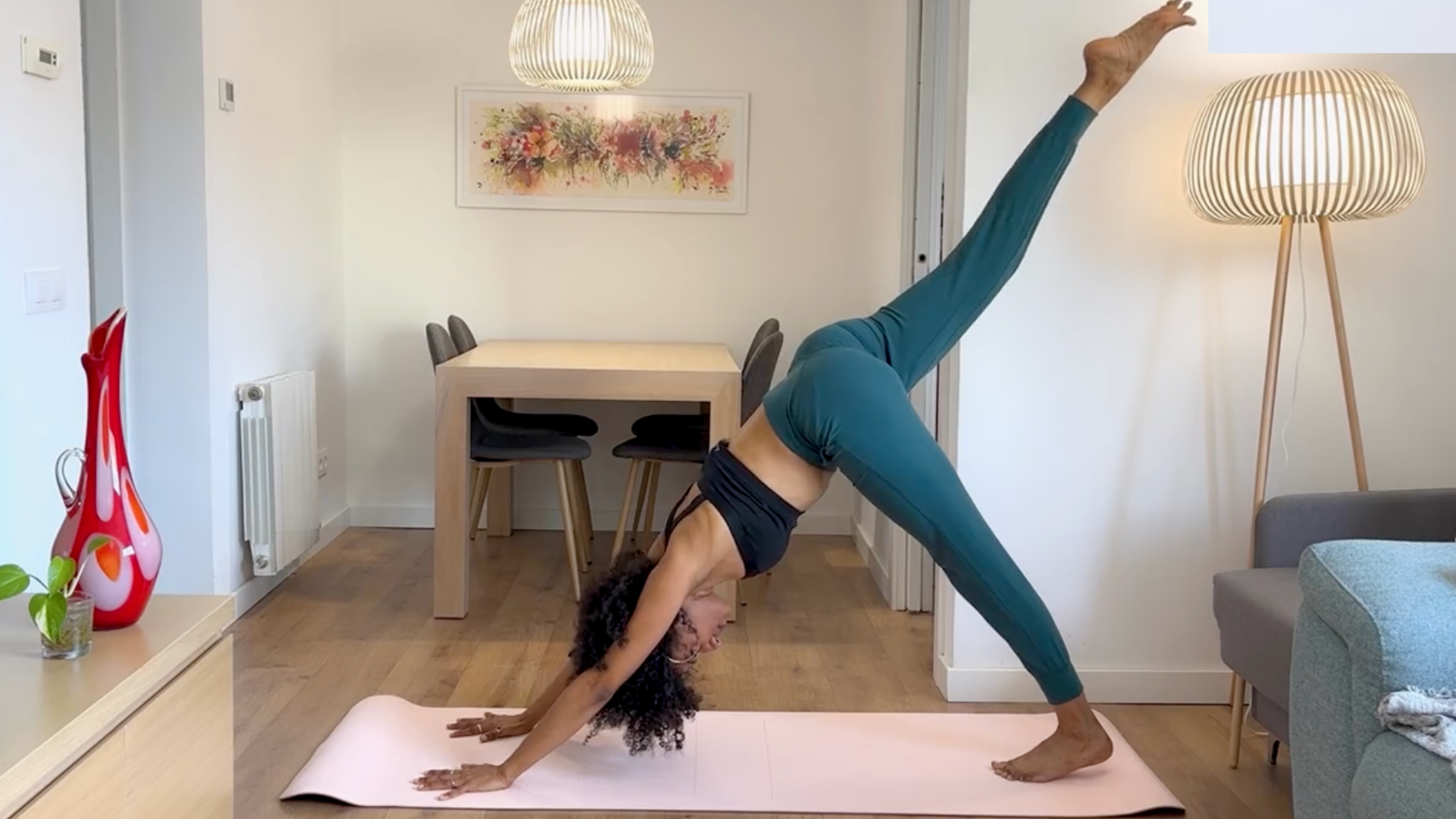 Yoga teacher practicing Three-Legged Dog.