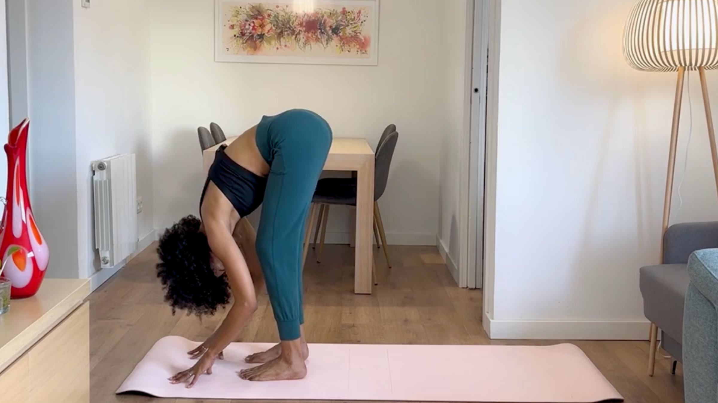 Yoga teacher practicing Standing Forward Bend.