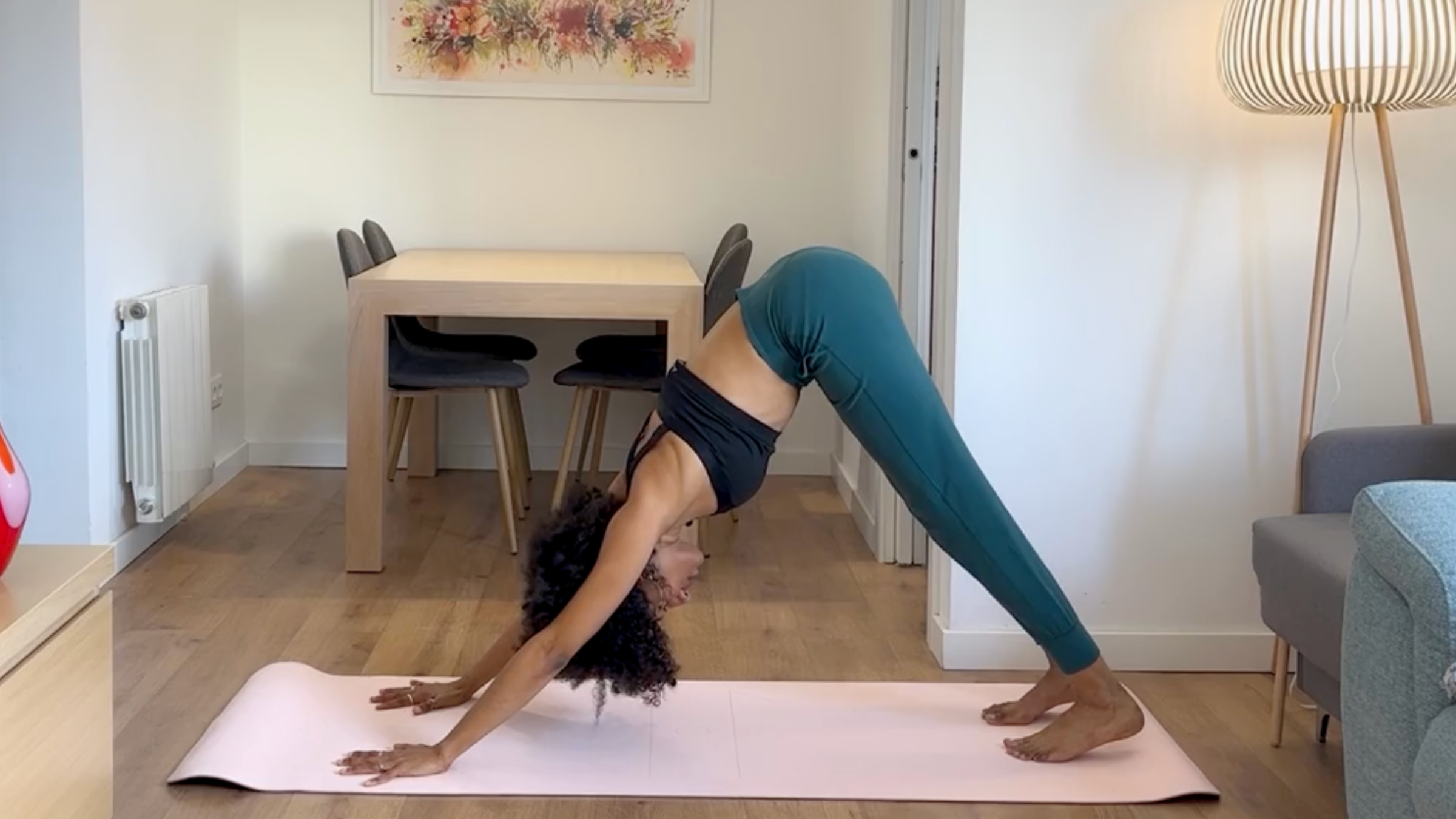 Yoga teacher practicing Downward-Facing Dog.