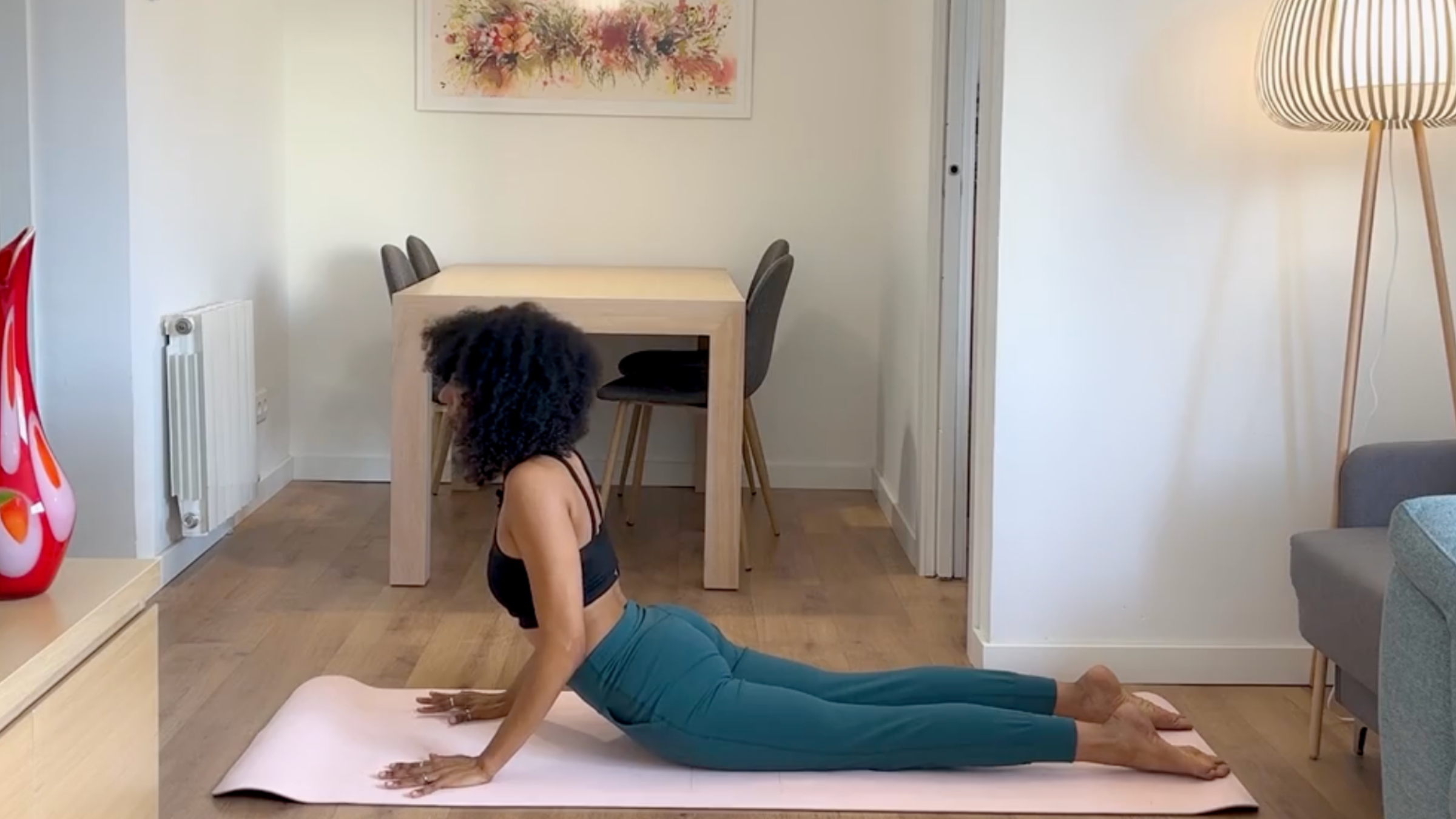 Yoga teacher practicing Cobra Pose.